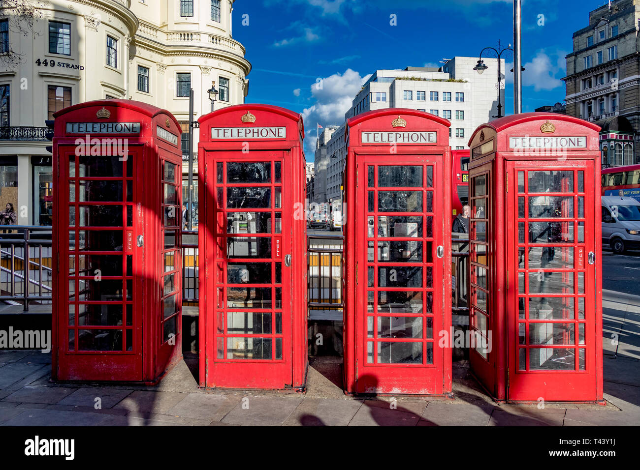 A row of Red public telephone boxes on The Strand at The junction with Duncannon St ,London, UK Stock Photo