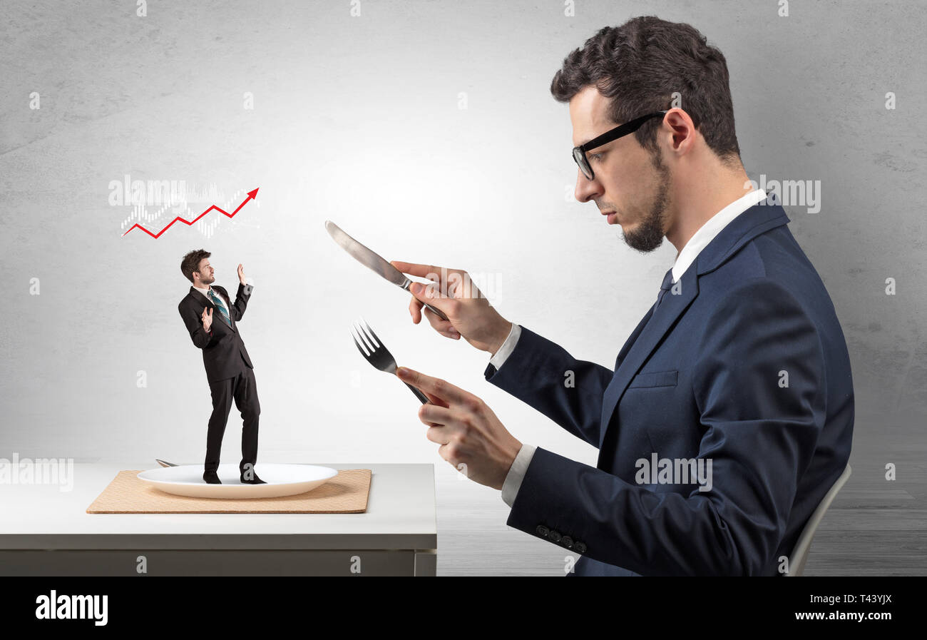 Big boss eating small businessman with knife and fork Stock Photo - Alamy