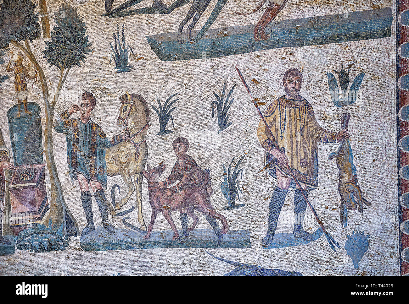 Hunters hunting. Roman mosaic floor of the Room of The Small Hunt, no 25 - Roman mosaics at the Villa Romana del Casale ,  circa the first quarter of  Stock Photo