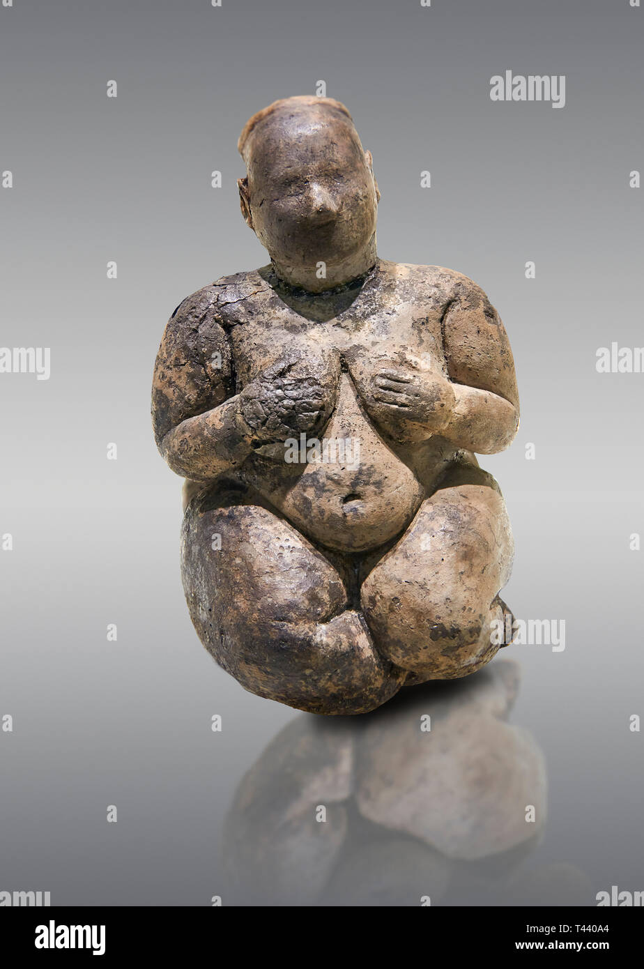 Seated terracotta goddess, probably a sign of fertility. Catalhoyuk Collections. Museum of Anatolian Civilisations, Ankara. Against a grey background Stock Photo