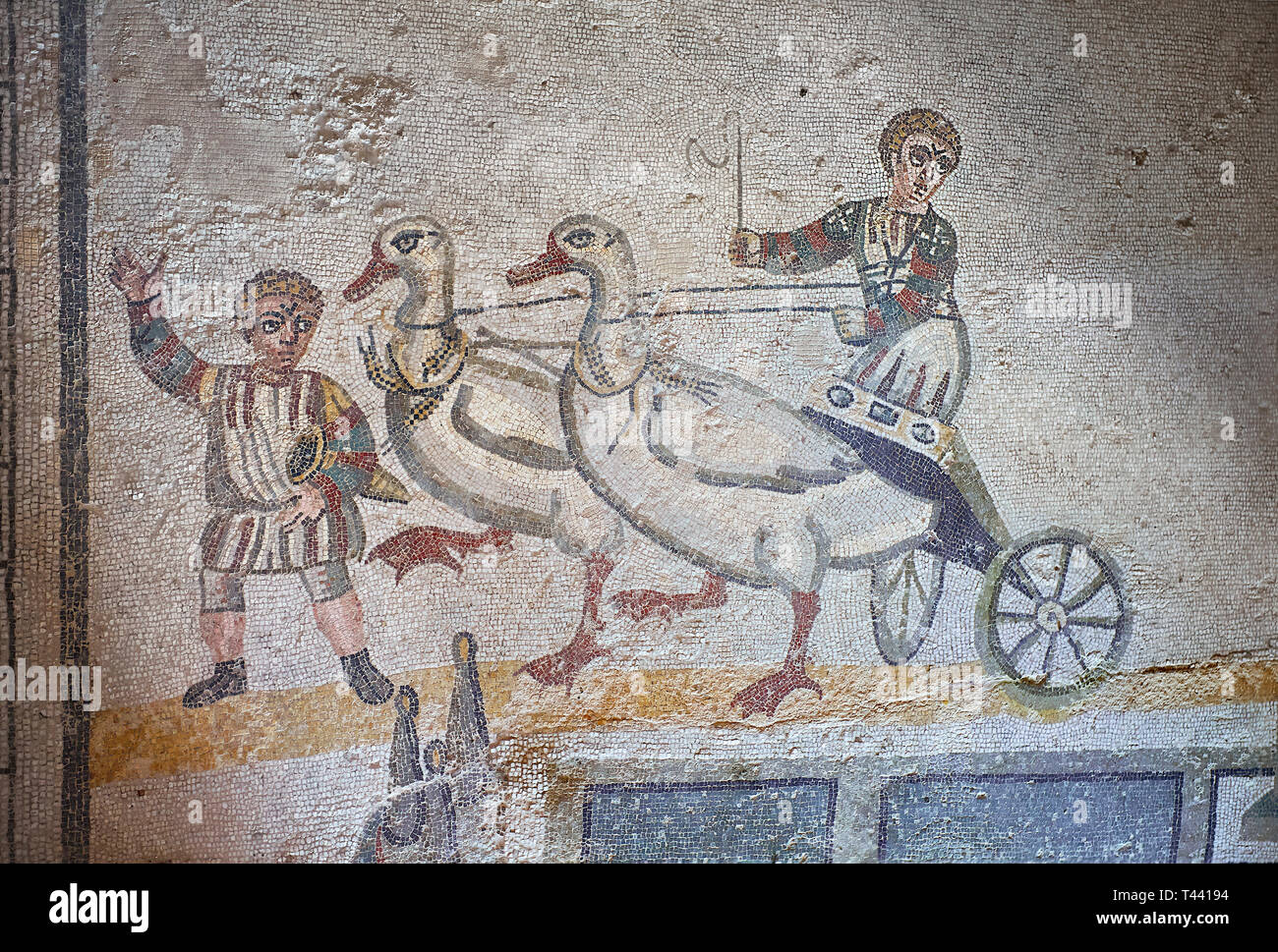 Close up picture of the Roman mosaics of the room of the Small Circus depicting Roman boys riding small chariots pulled by geese in a small circus, Th Stock Photo