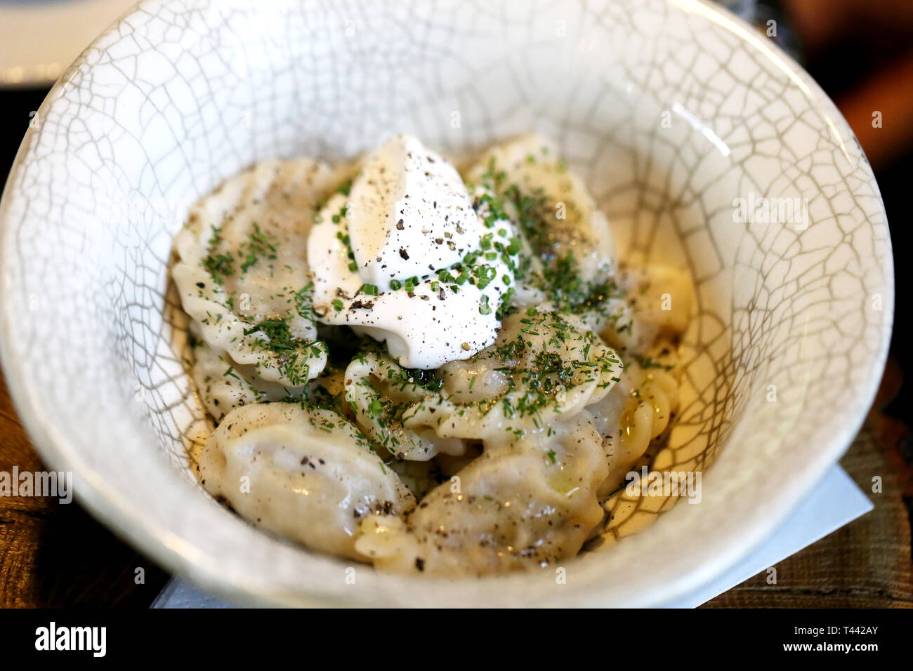 Delicious dumplings with cheese and onions in a bowl photographed close-up Stock Photo