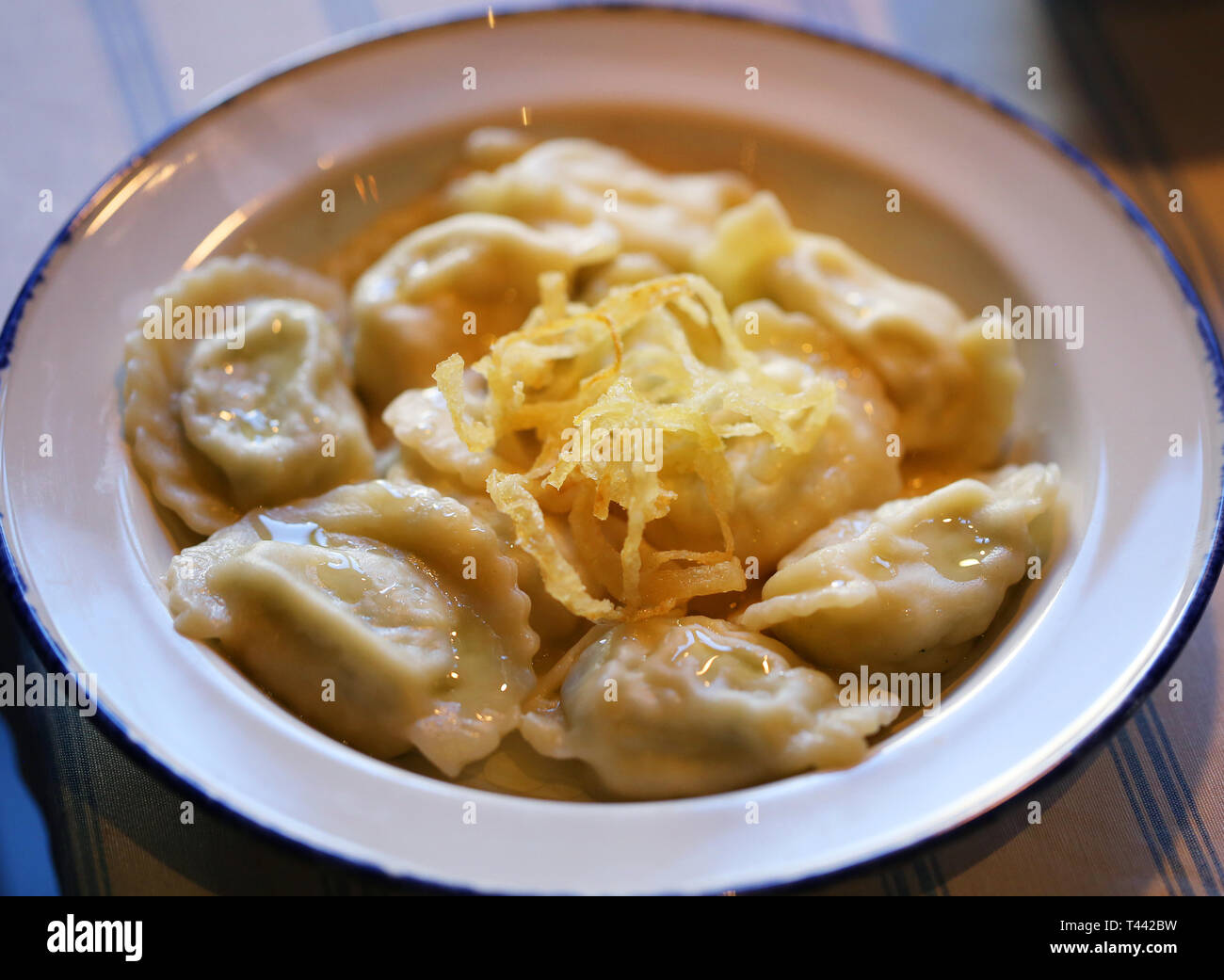 Delicious dumplings with cheese and onions in a bowl photographed close-up Stock Photo
