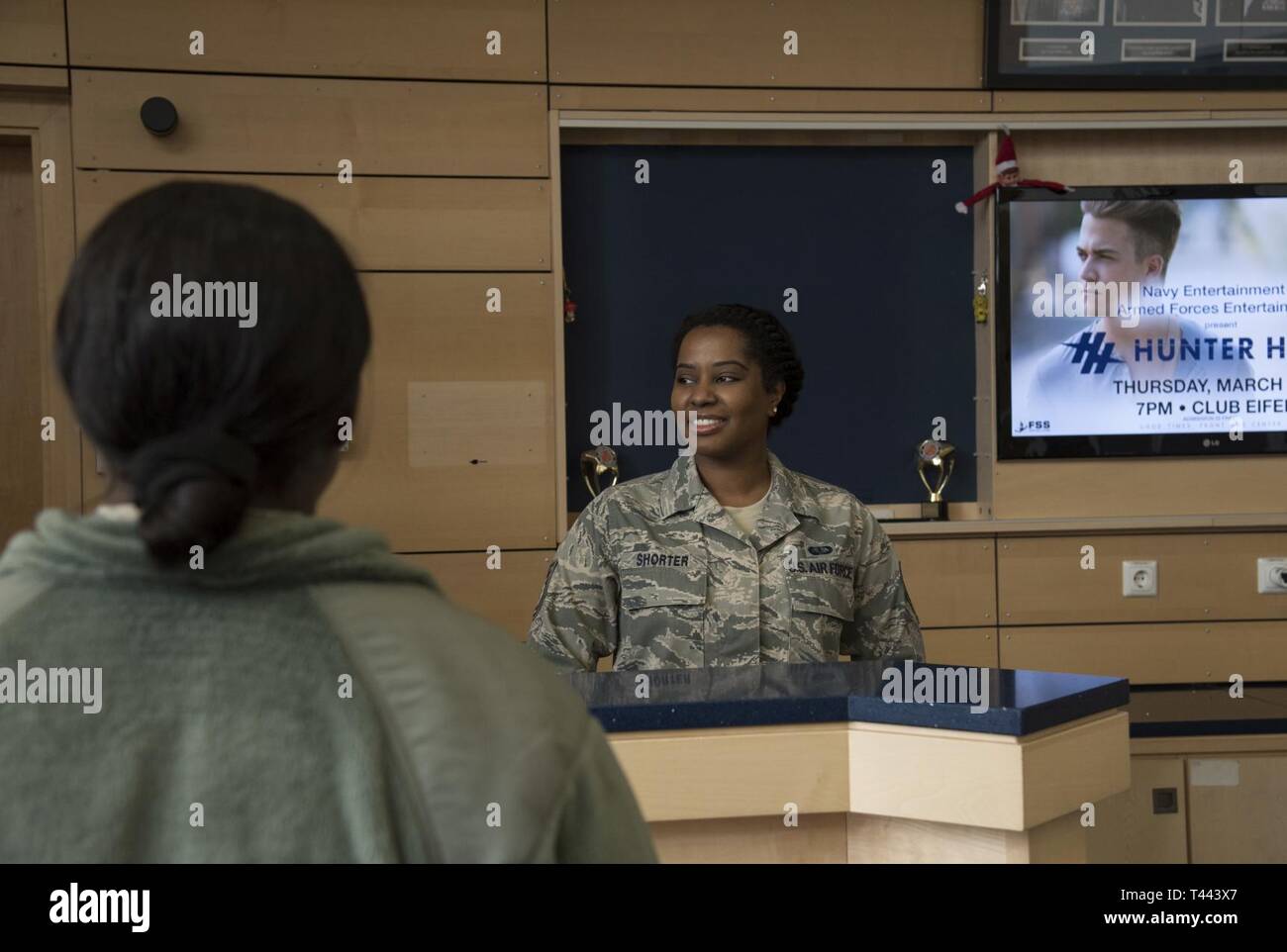 Staff Sgt. Folami Shorter, a services specialist with the 108th Force Support Squadron from Joint Base McGuire-Dix-Lakehurst, N.J., greets patrons at the George Price Gymnasium at Spangdahlem Air Base, Germany, March 13, 2019. Air National Guard services specialists manned the front desk and assisted with required physical fitness tests for the 52nd Fighter Wing's active duty Airmen during the guard unit's two-week annual training. Stock Photo
