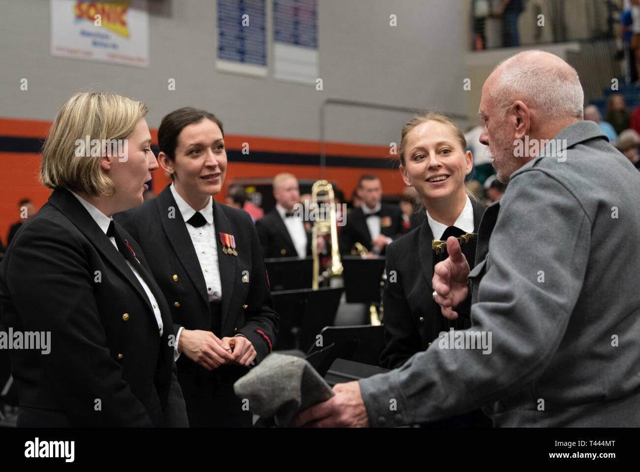 MURFREESBORO, Tenn. (March 16, 2019) Members of the flute section speak with a member of the audience during intermission at the Navy Band concert at Blackman High School in Murfreesboro, Tennessee. The U.S. Navy Band performed in 10 states during its 23-city, 5,000-mile tour, connecting communities across the nation to their Navy. Stock Photo