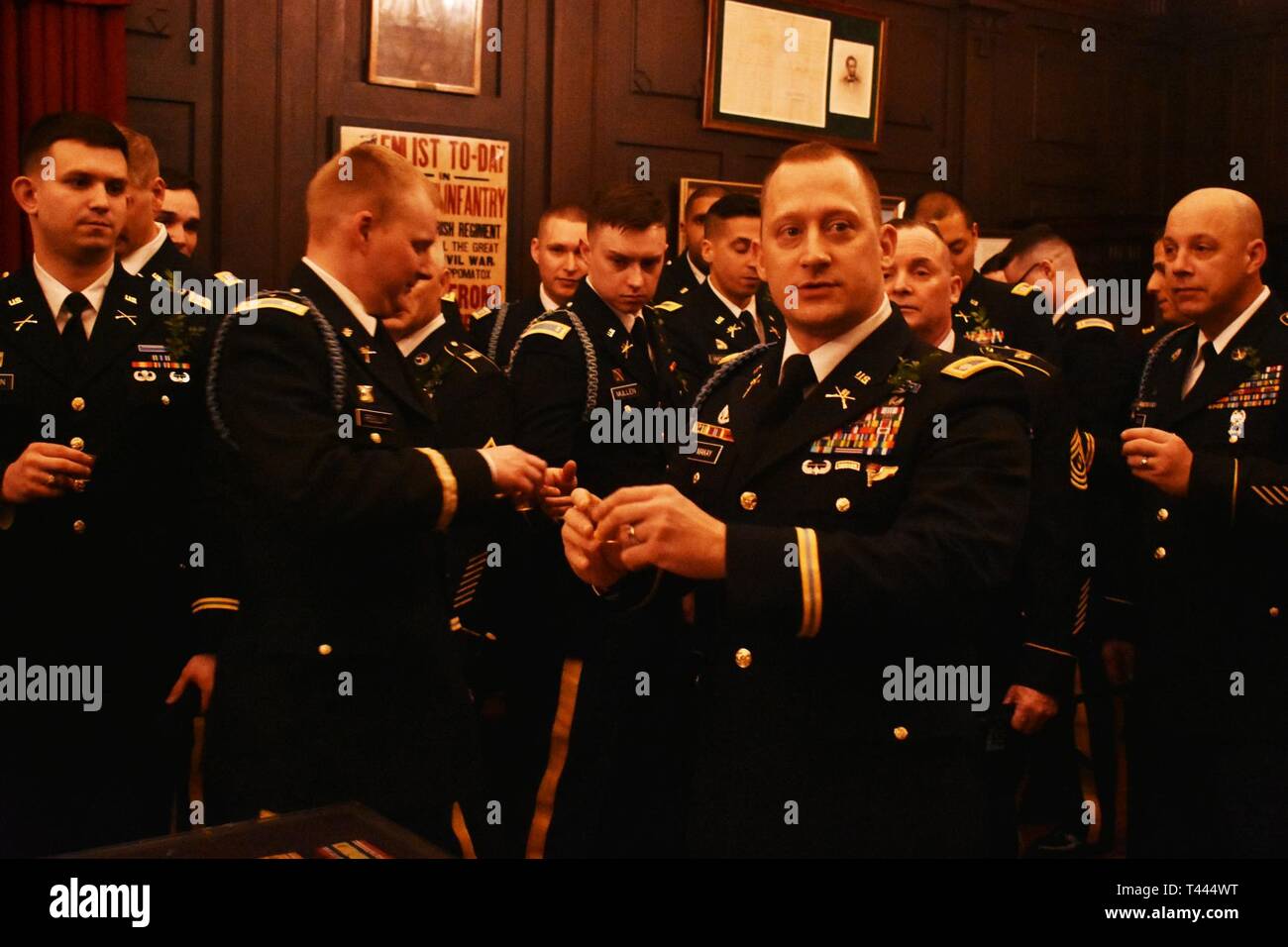 New York Army National Guard  Lt. Col. Don MaKay, 69th Infantry Regiment, prepares to offer the traditional Irish Whiskey toast  at the Lexington Armory, Manhattan, N.Y., March 16, 2019, as the 1st Battalion, 69th Infantry prepared to lead the world's largest St. Patrick's Day parade. As a tradition, the commanders and senior noncommissioned officers, along with some guests of the 69th infantry regiment, raise a toast prior to marching to Mass at St. Patrick's Cathedral, which is held for the unit before the parade.(N.Y. Army National Guard Stock Photo