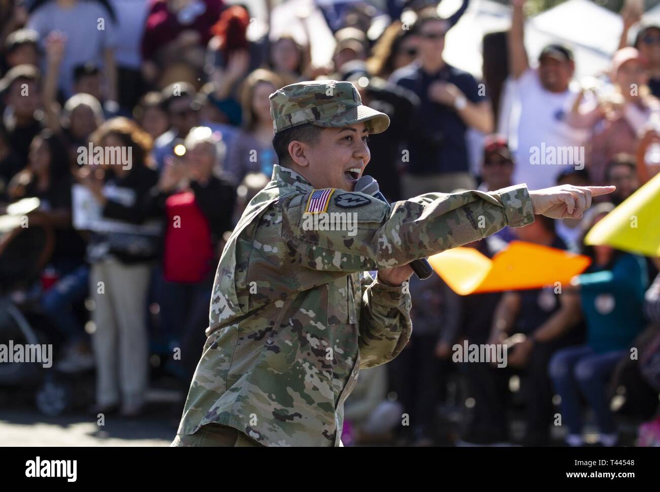 California State Military Reserve Chief Warrant Officer 2 Rochelle Sonza leads about 1,000 people in a wave during Sunburst Youth Challenge Academy's Class 23 Family Day, March 16, 2019, at Joint Forces Training Base, Los Alamitos, California. More than 200 teens, ages 16-18, in Class 23 are about halfway through Sunburst's 5.5 month residential program which focuses on academics, life skills, leadership, goal setting and success. Stock Photo