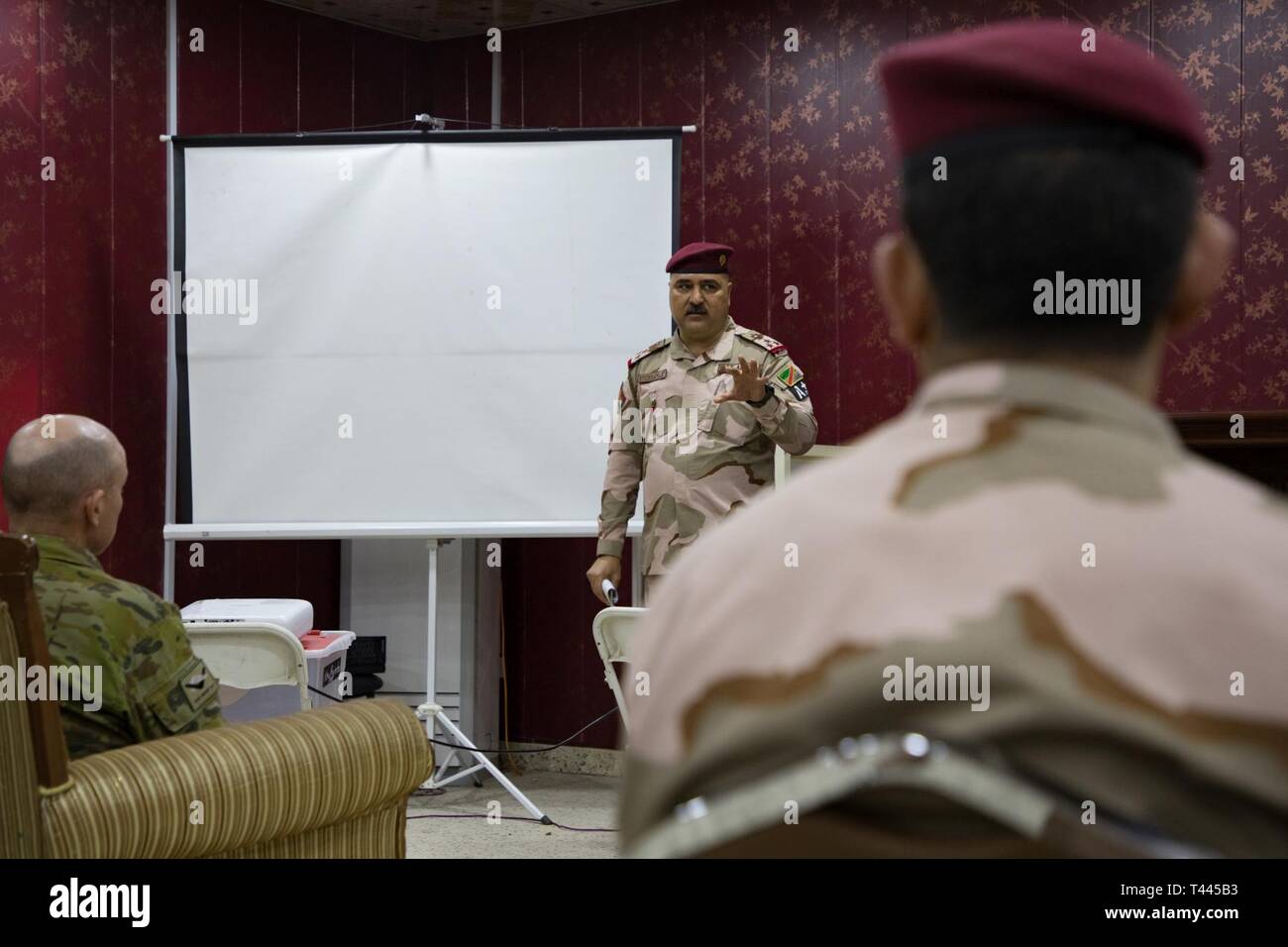 Iraqi Army Brig. Gen.l Husaian Mandel Jarih provides feedback to senior officers to Task Group Taji-8 (TGT-8) about the training delivered by the 2nd Non-Commission Officer School of Infantry (SINCO2) at Camp Taji, Iraq, March 16, 2019. TGT-8 is a combined Australian-New Zealand Task Group that provides the Iraqi Security Forces with training to enable the stabilization of areas cleared of Daesh. The Coalition will continue to stand alongside our Iraqi partners for as long as required to en-sure the lasting defeat of Daesh. Stock Photo