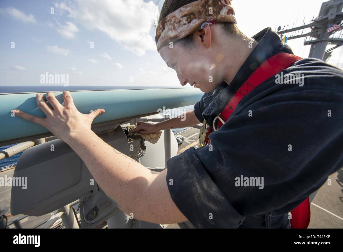 U.S. 5TH FLEET AREA OF OPERATIONS (March 17, 2019) Electronics Technician 3rd Class Sara Head inspects the SPS-73 radar aboard the Wasp-class amphibious assault ship USS Kearsarge (LHD 3). Kearsarge is the flagship for the Kearsarge Amphibious Ready Group and, with the embarked 22nd Marine Expeditionary Unit, is deployed to the U.S. 5th Fleet area of operations in support of naval operations to ensure maritime stability and security in the Central Region, connecting the Mediterranean and the Pacific through the western Indian Ocean and three strategic choke points. Stock Photo