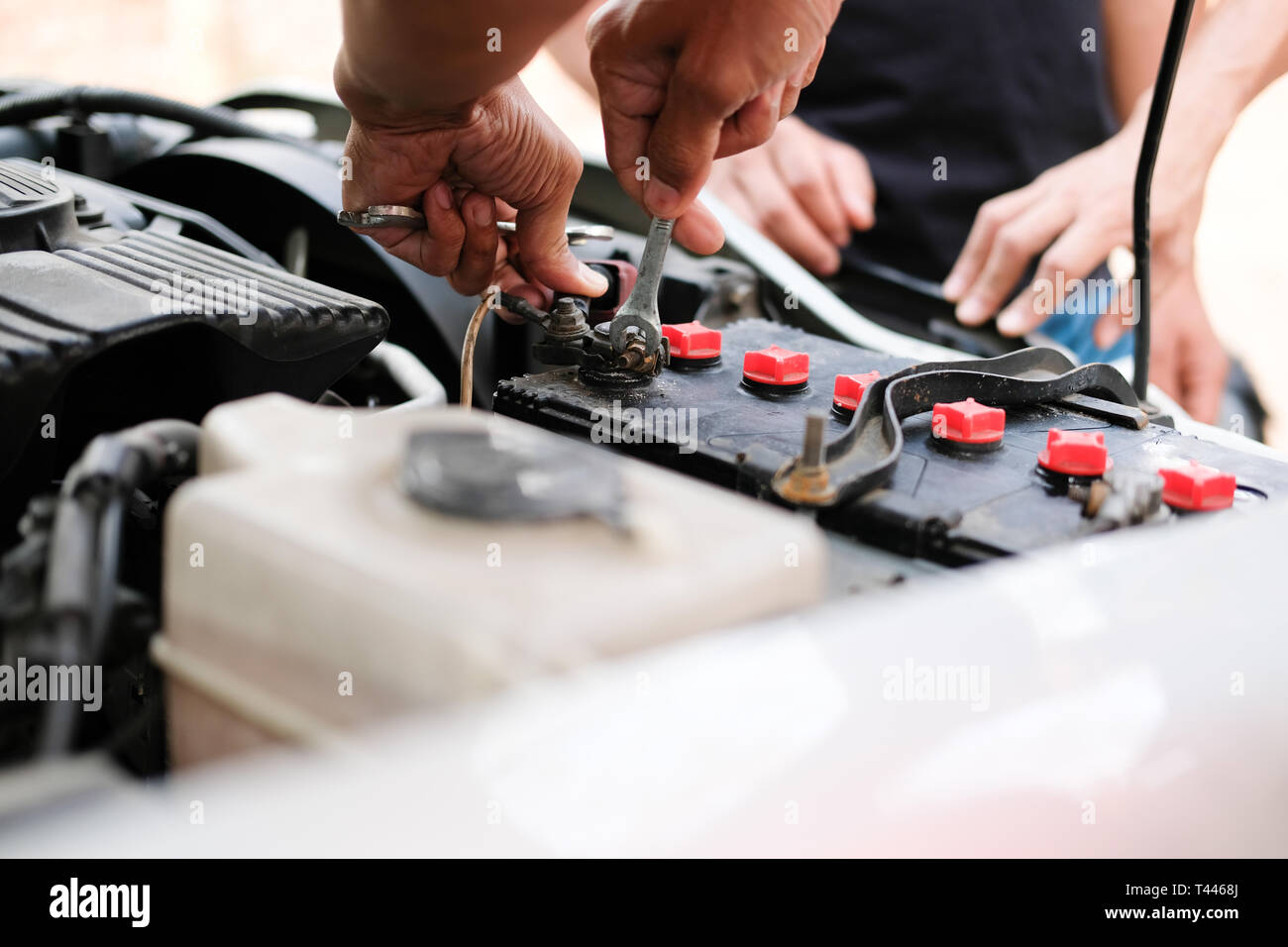 auto mechanic use jumper cables to charge dead car battery Stock Photo Alamy