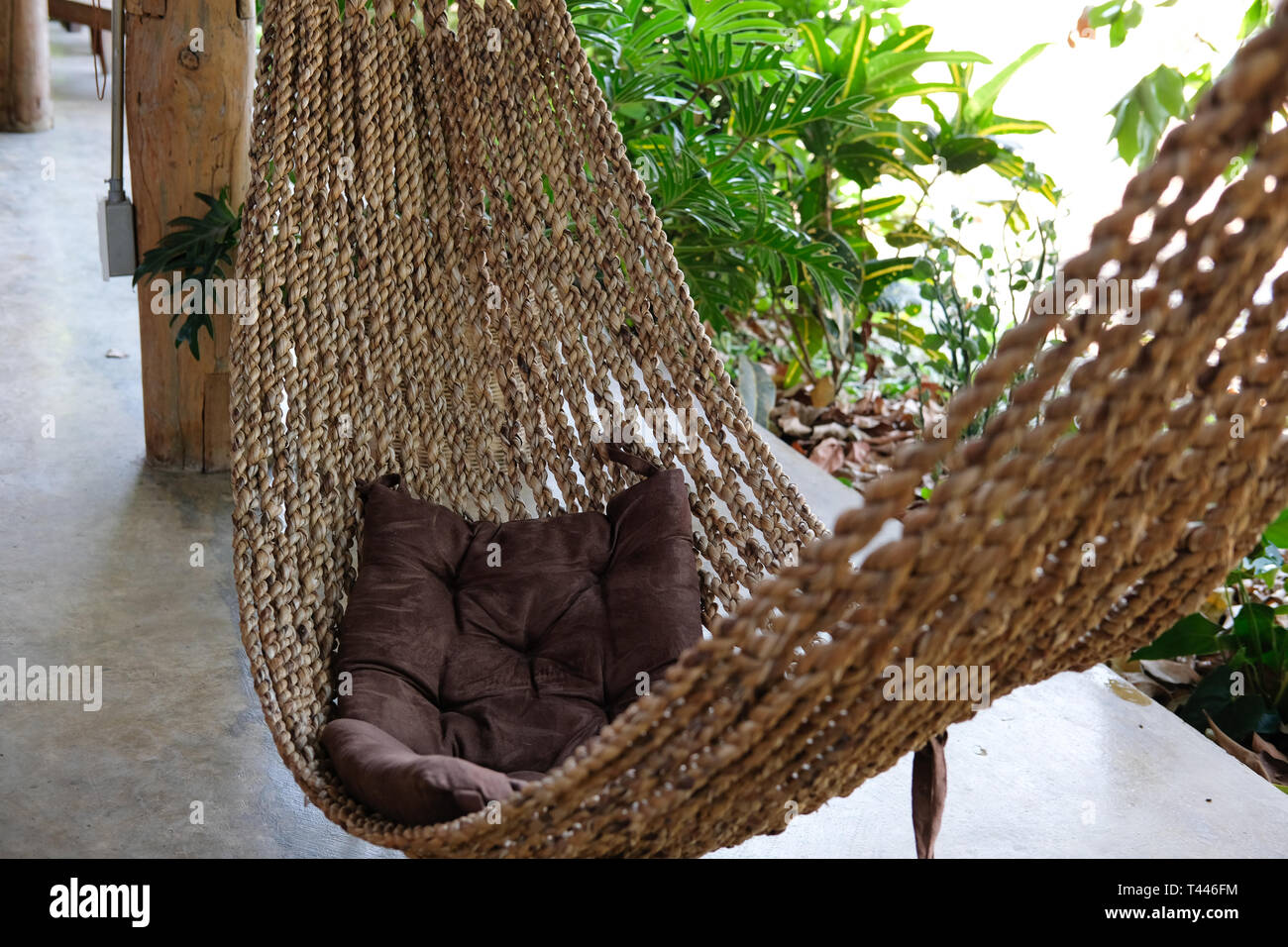 hammock cradle for relaxing on terrace near garden. cozy lifestyle at home  Stock Photo - Alamy