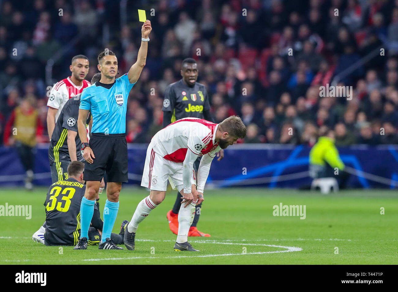 10th of april 2019 Amsterdam, The Netherlands Soccer Champions League Ajax v Juventus   Lasse Schone of Ajax receives yellow card scheidsrechter Felix Brych (GER) Stock Photo