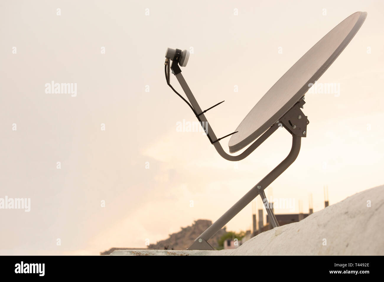 Installed Satellite dish or DTH or Direct to home tv on the roof Stock Photo