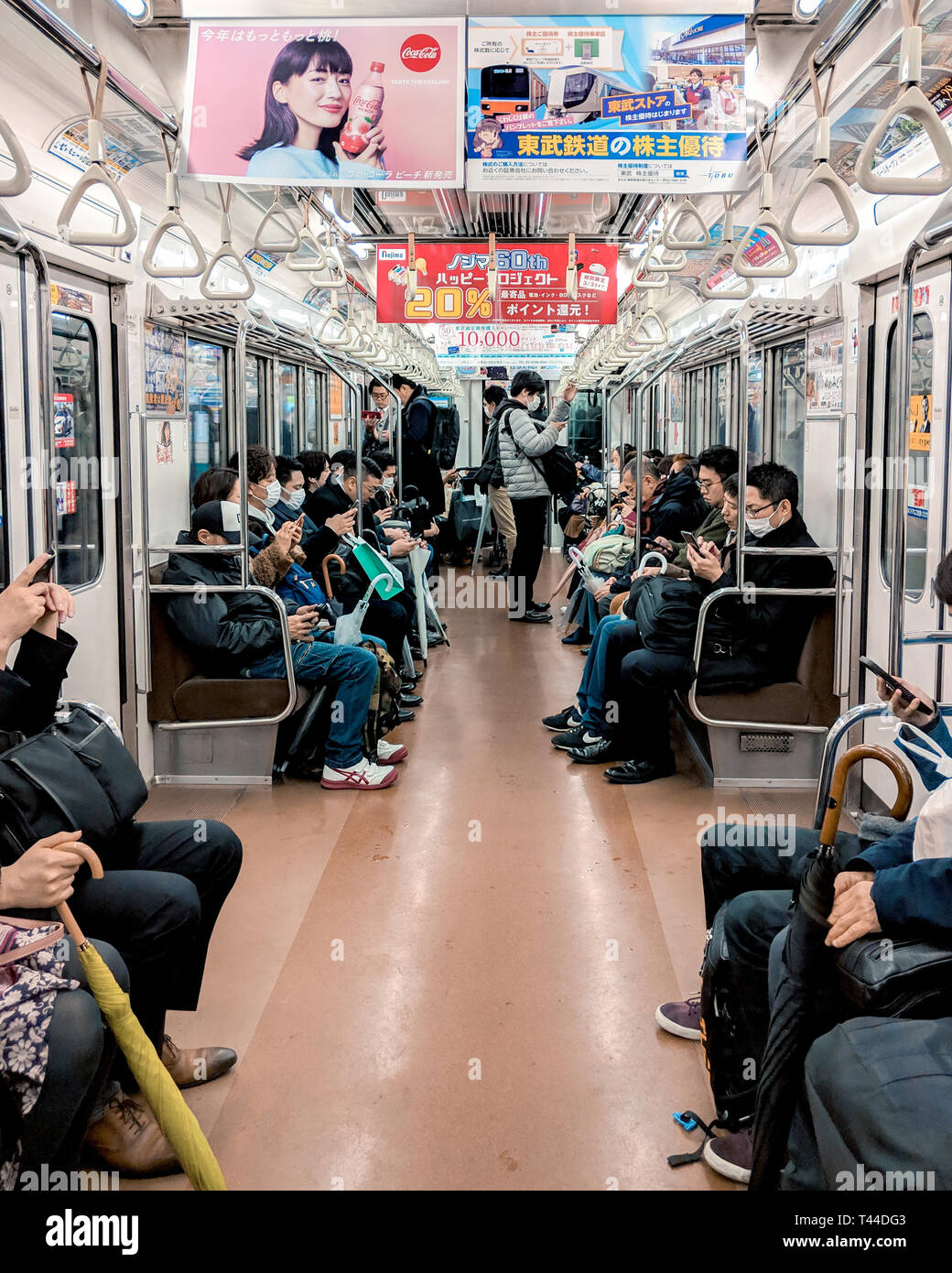 People seen seated inside the Tokyo Metro system, Japan. Stock Photo