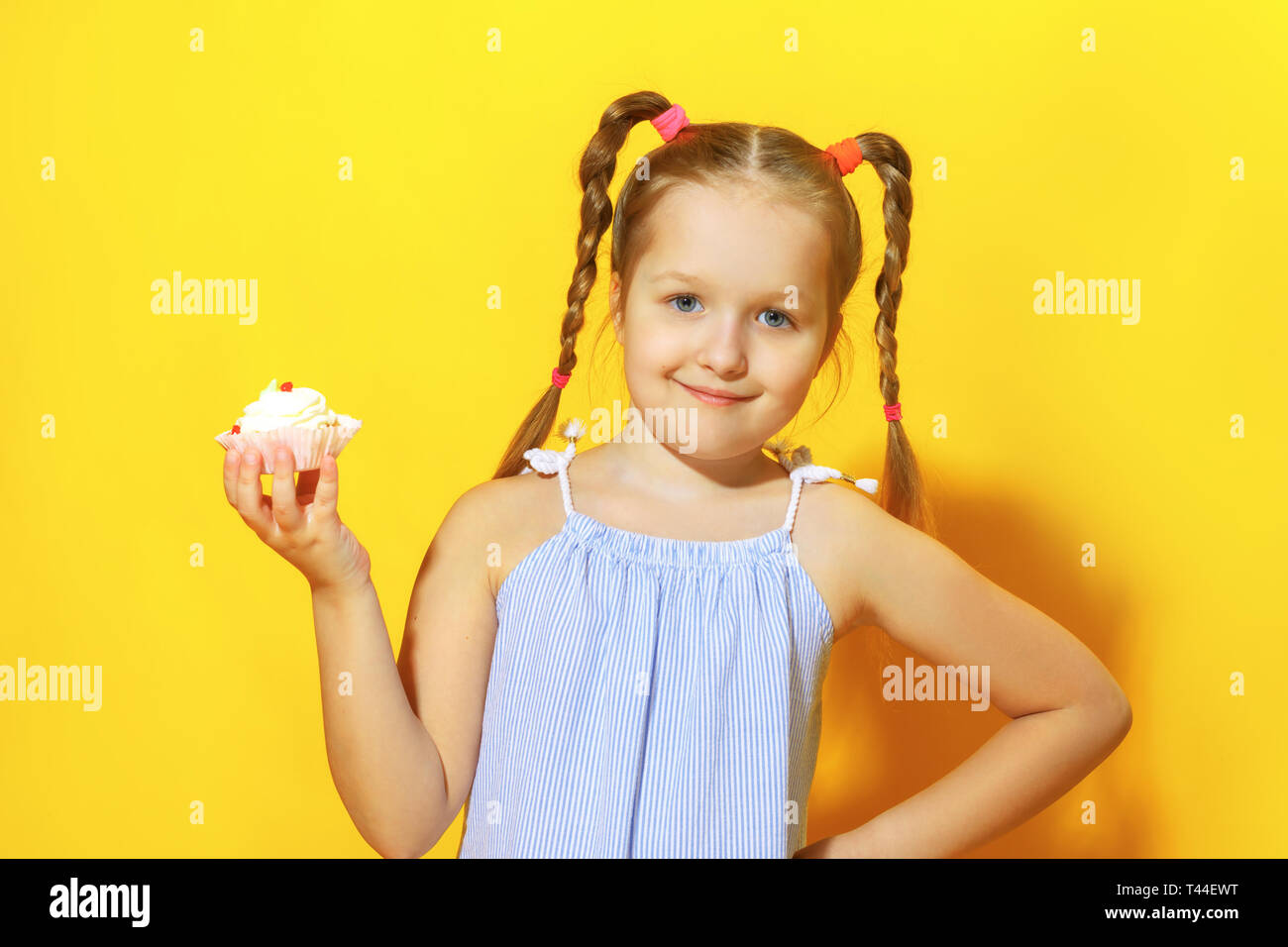 Portrait Of A Beautiful 3-year-old Girl With Pigtails, Holding A Cup In Her  Hands, Looking Up With An Amazed Expression - Isolated On White Stock  Photo, Picture and Royalty Free Image. Image