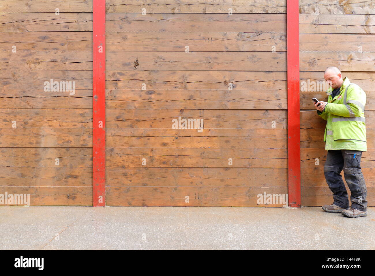 A construction worker in hi viz using a mobile phone. Stock Photo