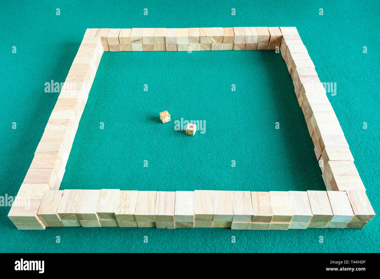 starting walls of mahjong, tile-based chinese strategy board game on green baize table Stock Photo