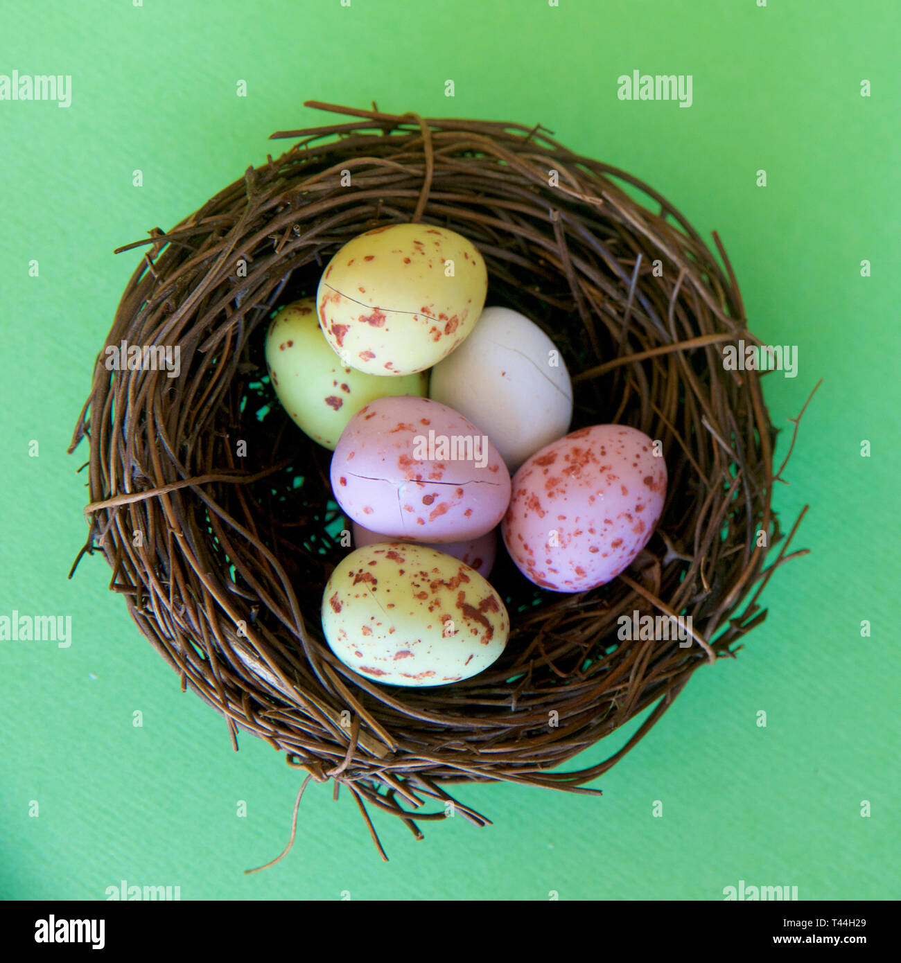 Speckled speckled Easter eggs in a brown nest signifying new life. Stock Photo