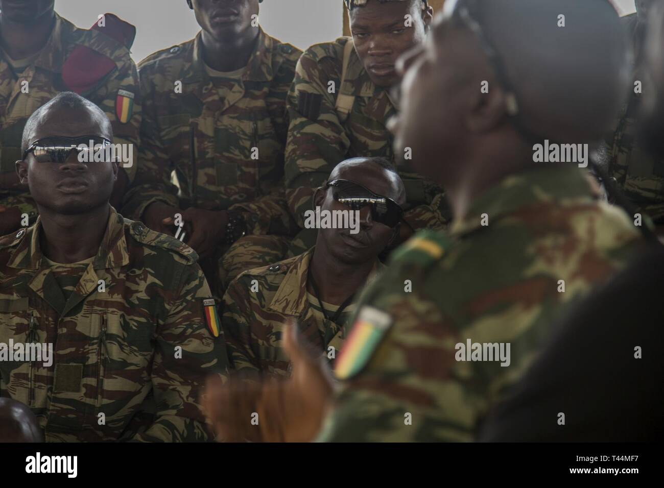 A Guinean Officer gives feedback on a Sensitive Site Exploitation (SSE) class at base camp Loumbila, Burkina Faso, Feb 20, 2019. Experts from Burkinabe law enforcement took the lead  on training multinational soldiers during the exercise. Stock Photo