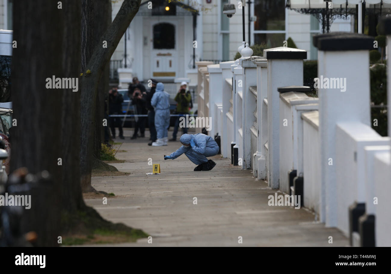 Forensic officers at scene near the Ukrainian Embassy in Holland Park, west London after police fired shots after the ambassador's car was 'deliberately rammed'. Stock Photo