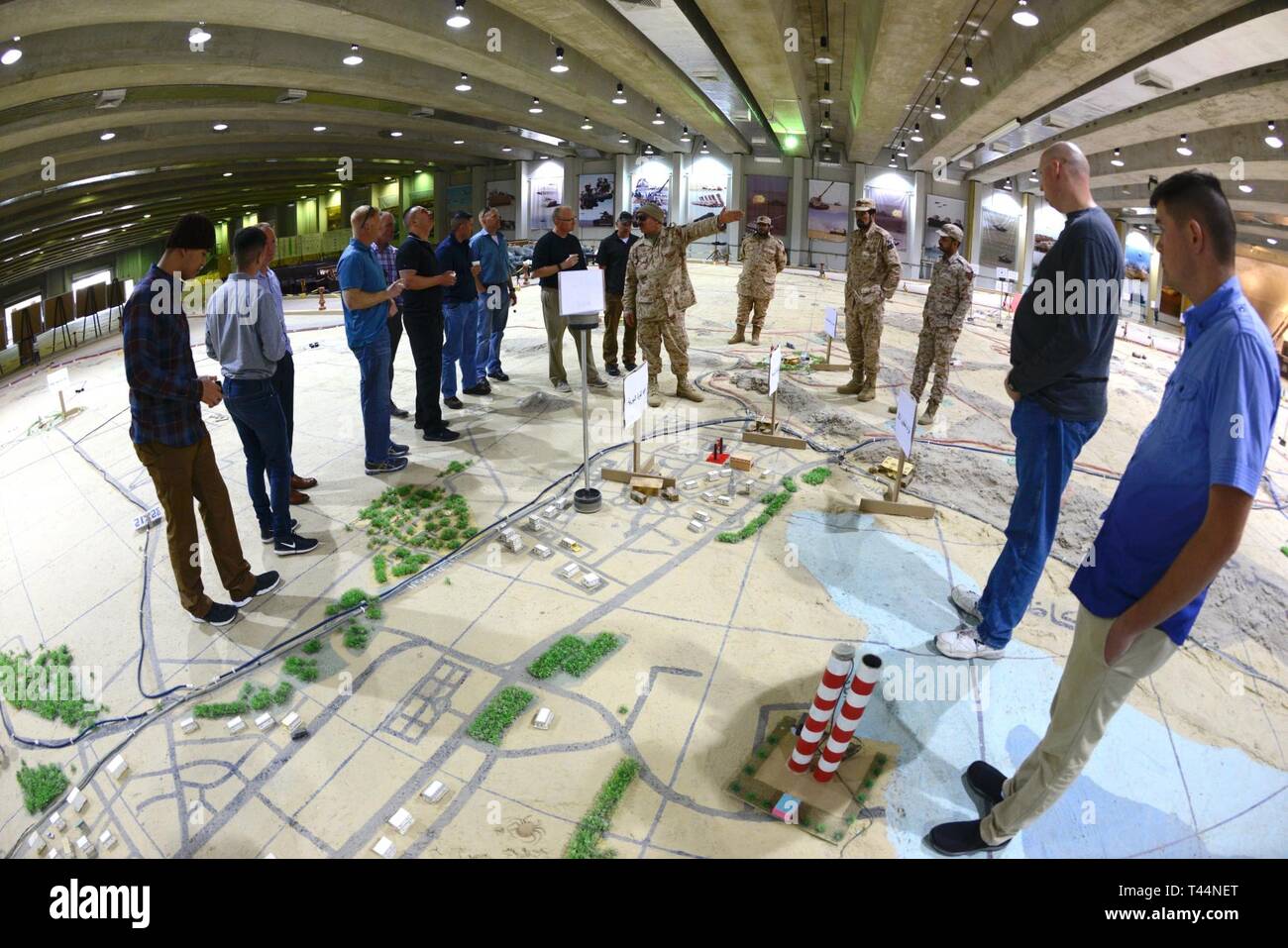 Kuwaiti military veterans discuss the battle between Kuwait and Iraq forces during the 1990 invasion of Kuwait with counterparts from the U.S. Army’s 34th Red Bull Infantry Division at the Kuwait Land Force’s 35th Armored Brigade compound, Feb. 20, 2019. The Red Bulls partnered with their Kuwaiti hosts to learn about the history of Saddam Hussein’s invasion of Kuwait and the national and international response that liberated the nation. The Soldiers, currently deployed to the region as Task Force Spartan, also visited the Al Qurain Marytr Museum to discover one story of a battle between local  Stock Photo