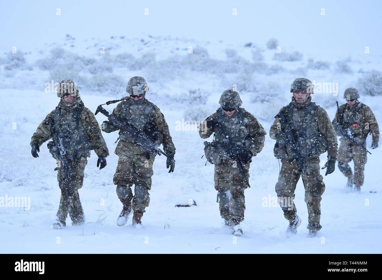 Soldiers from Charlie Company, 2-116th Cavalry Brigade Combat Team, Idaho Army National Guard, practice combined arms battalion, squad level infantry movements on the Orchard Combat Training Center, Jan. 20, 2019. The training combined dry fire rehearsal culminating in a live fire exercise. Stock Photo