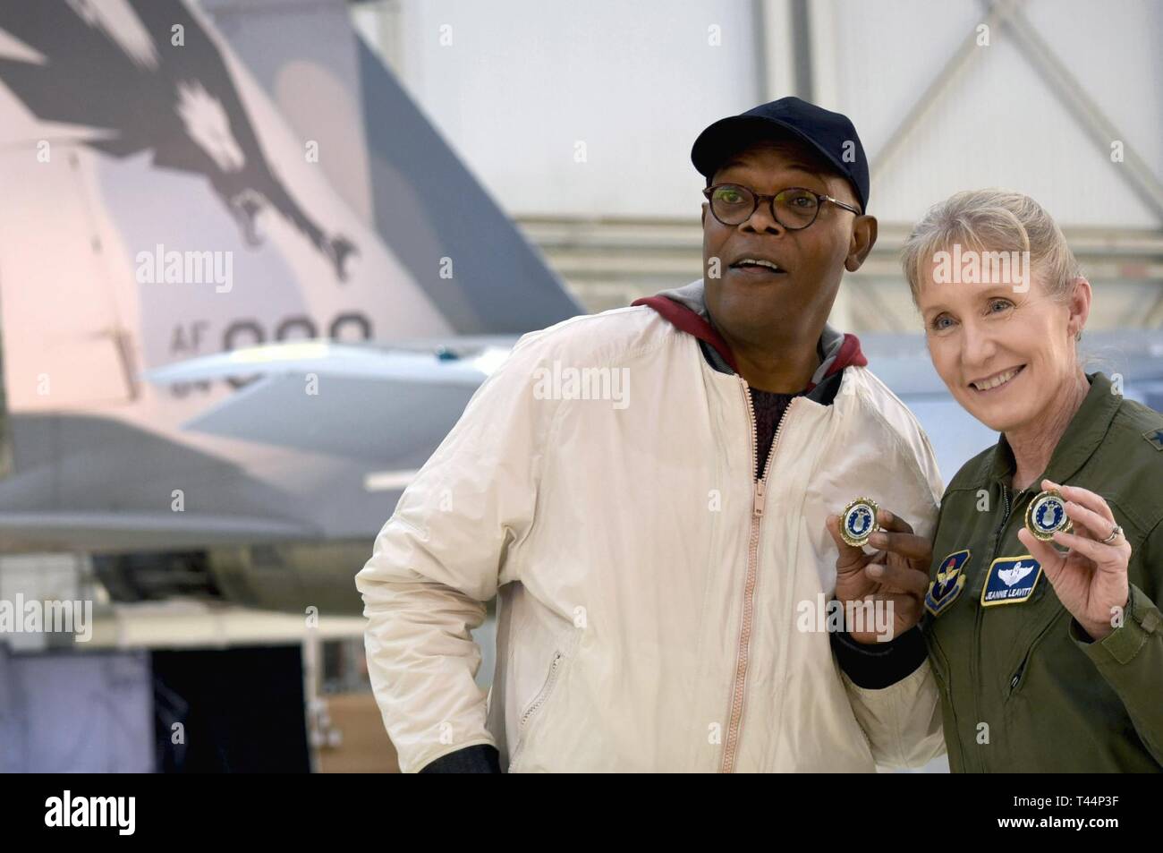 Actor Samuel L. Jackson poses with Gen. Jeannie Leavitt after receiving a challenge coin from her during a media event for 'Captain Marvel' at Edwards Air Force Base, California, Feb. 20, 2019. Leavitt, the first US Air Force female fighter, was a consultant on the movie, and Jackson reprised his Nick Fury role. Stock Photo