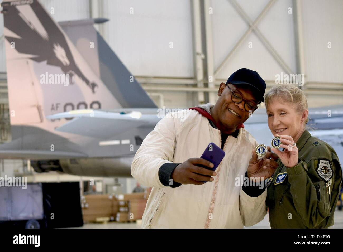 Actor Samuel L. Jackson takes a photo with Gen. Jeannie Leavitt after after receiving a challenge coin from her during a media event for 'Captain Marvel' at Edwards Air Force Base, California, Feb. 20, 2019. Leavitt, the first US Air Force female fighter, was a consultant on the movie, and Jackson reprised his Nick Fury role. Stock Photo