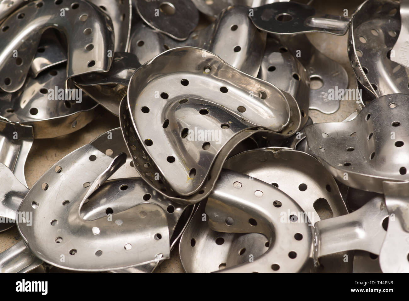 many chrome metal dental impression tray of various sizes Stock Photo