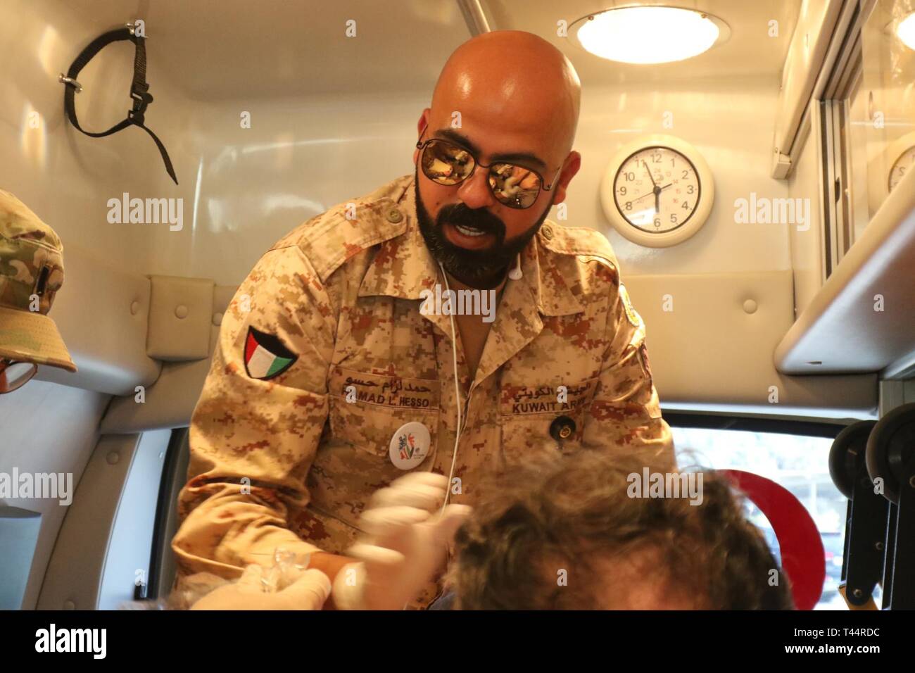 Kuwait Army Cpl. Hamad L. Hesso provides ambulatory care for a mock casualty at Kuwait North Military Medical Complex during Exercise Pacemaker Phase II  Feb. 21, 2019. The exercise is the second part of a three-phase joint medical exercise with KNMMC staff, the U.S. Army's 452d Combat Support Hospital, and Kuwait Chemical Operations Forces. Stock Photo