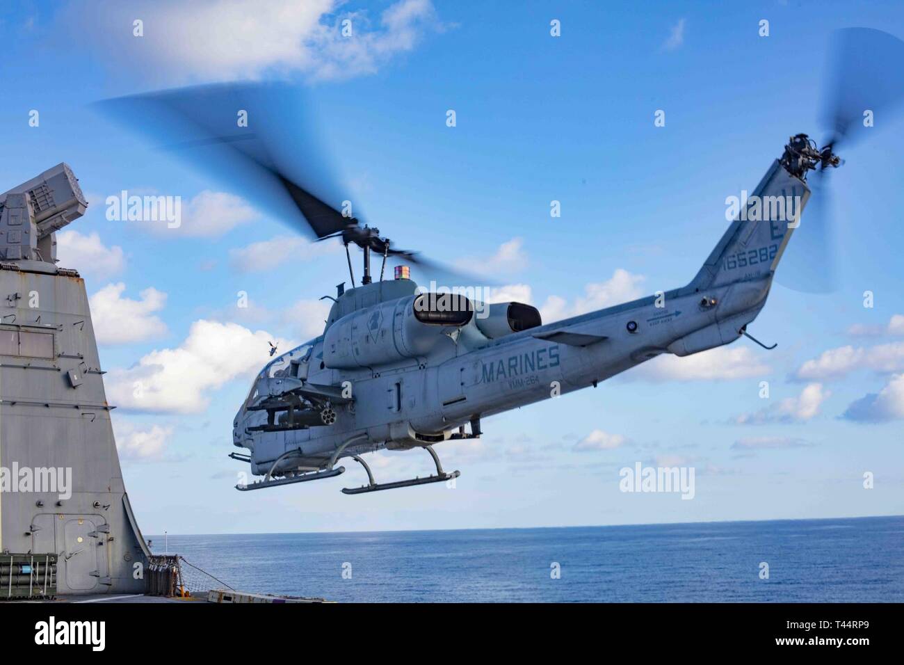MEDITERRANEAN SEA (Feb. 21, 2019) An AH-1W Super Cobra helicopter assigned to the “Black Knights” of Marine Medium Tiltrotor Squadron (VMM) 264 (Reinforced) departs the flight deck of the San Antonio-class amphibious transport dock ship USS Arlington (LPD 24), Feb. 21, 2019. Arlington is on a scheduled deployment as part of the Kearsarge Amphibious Ready Group in support of maritime security operations, crisis response and theater security cooperation, while also providing a forward naval presence. Stock Photo