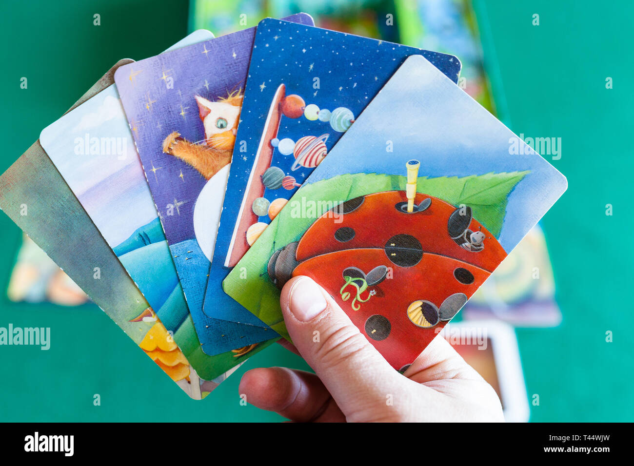MOSCOW, RUSSIA - APRIL 3, 2019: player shows picture cards during Dixit  board game . Dixit is a card game created by Jean-Louis Roubira and first  publ Stock Photo - Alamy
