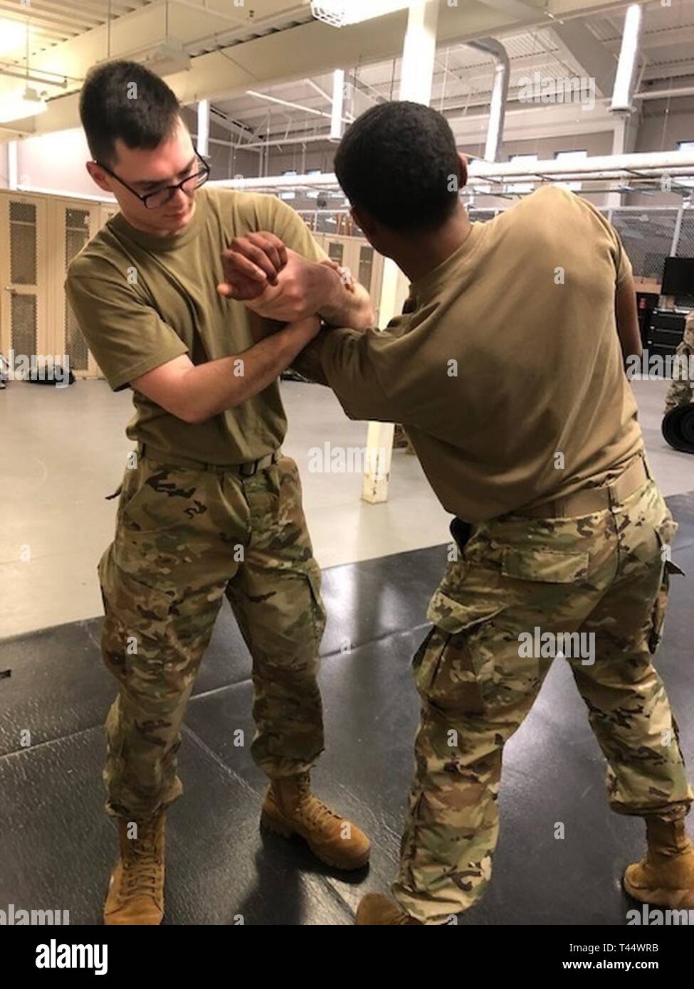 PVT Jared Whiting and PV2 Dorian Rivera, both Military Police Soldiers with the 194th Military Police Company, 716th Military Police Battalion, practice their mechanical arm holds as an effective way to subdue a non-compliant subject. Stock Photo