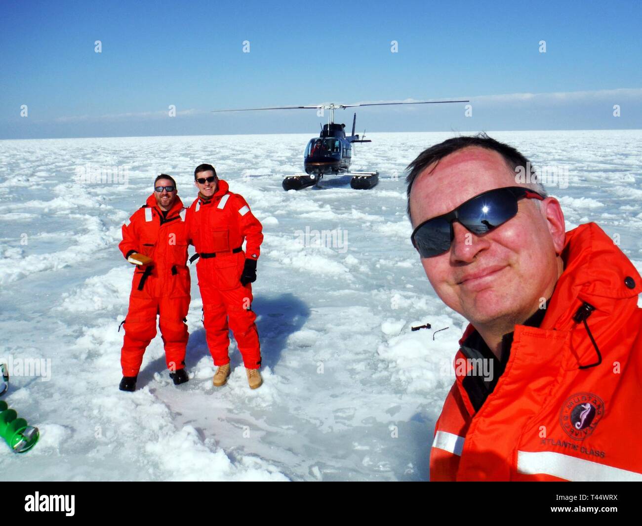U.S. Army Corps of Engineers Buffalo District team members Lt. Col. Jason A. Toth and Andrew Armstrong, Frank Seglenieks from Environment and Climate Change Canada, and members of the International Niagara Working Committee conduct a helicopter ice-thickness measurement flight on Lake Erie, Feb. 22, 2019.     Each winter, the INWC conducts two helicopter ice-thickness measurement flights and two survey flights of the Eastern Basin of Lake Erie to assess ice conditions and determine when the ice boom can be removed from the mouth of the Niagara River. Stock Photo