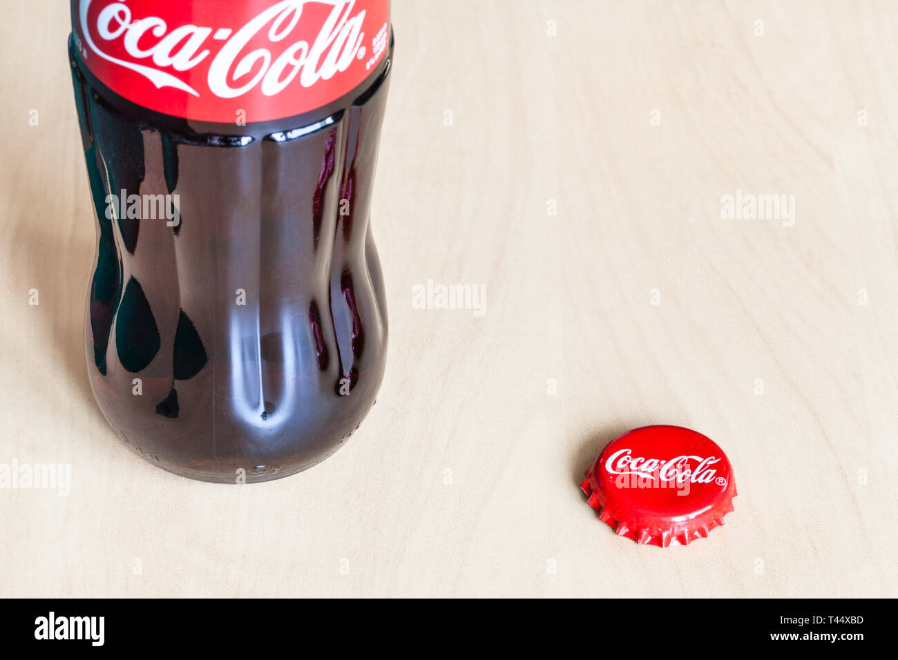 https://c8.alamy.com/comp/T44XBD/moscow-russia-april-4-2019-glass-bottle-and-used-crown-cork-bottle-cap-from-coca-cola-beverage-on-wooden-board-coca-cola-coke-is-carbonated-so-T44XBD.jpg