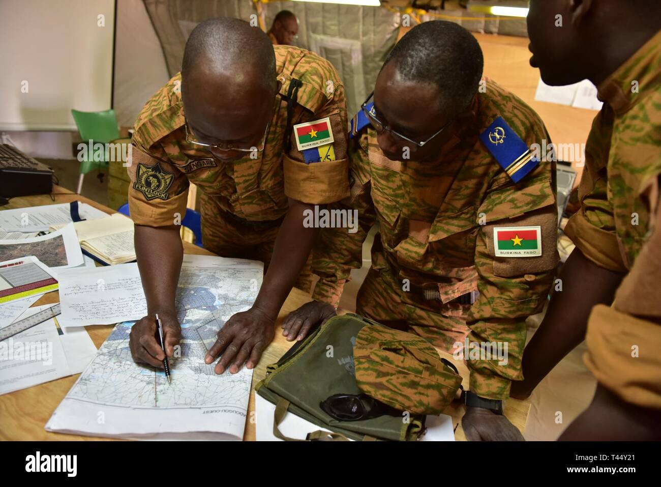 Burkina Faso Army leadership staying at base camp Loumbila conduct operational planning on Feb. 24, 2019 during exercise Flintlock 19. This team of Burkina Faso military leaders are in charge of providing command and control for all multinational western partners in Loumbila during the exercise's scenerio days. Flintlock provides military training opportunities that help foster relationships of peace, security, and cooperation. Stock Photo