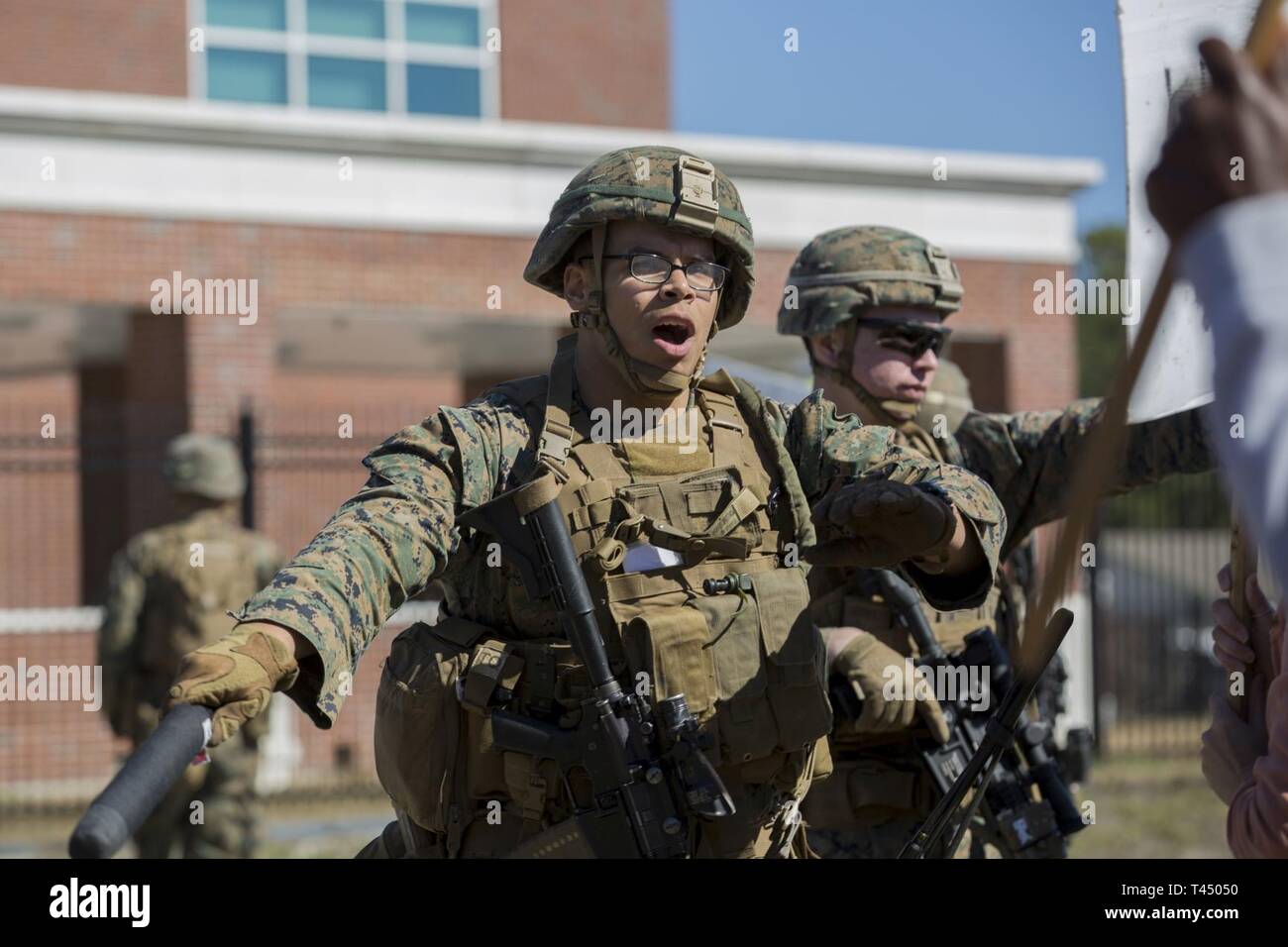 Marine Sgt. Anthony Ramos deescalates a simulated hostile situation with rioters during a noncombatant evacuation operation training event on Stone Bay, North Carolina, Feb. 25, 2019. The purpose of NEO exercise is to familiarize Marines with civilian evacuation, increase crowd control proficiency, and employ appropriate escalation of force procedures. Ramos is an infantry Marine with 1st Battalion, 8th Marine Regiment, 24th Marine Expeditionary Unit. Stock Photo