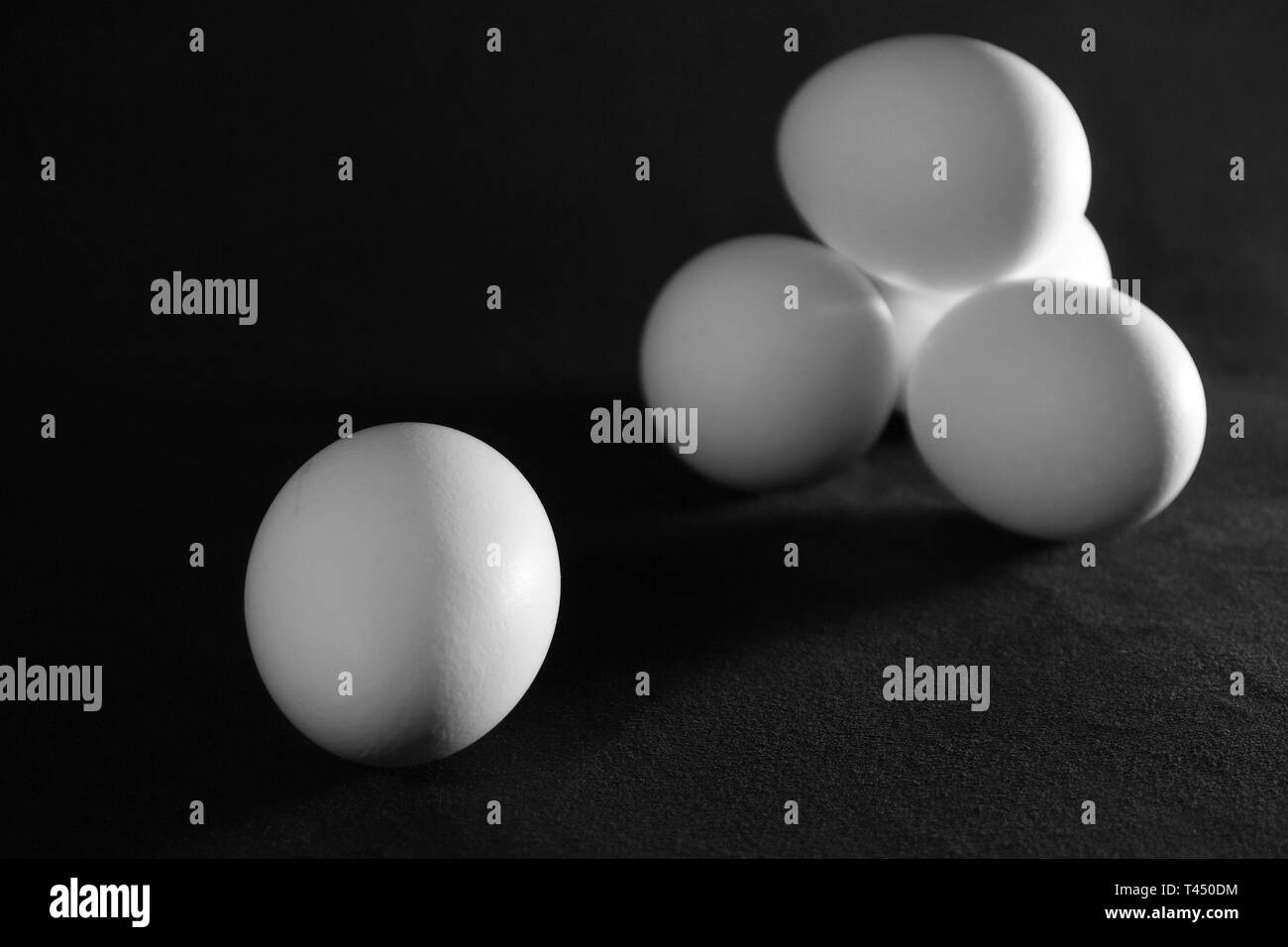 White chicken eggs on black background Stock Photo - Alamy
