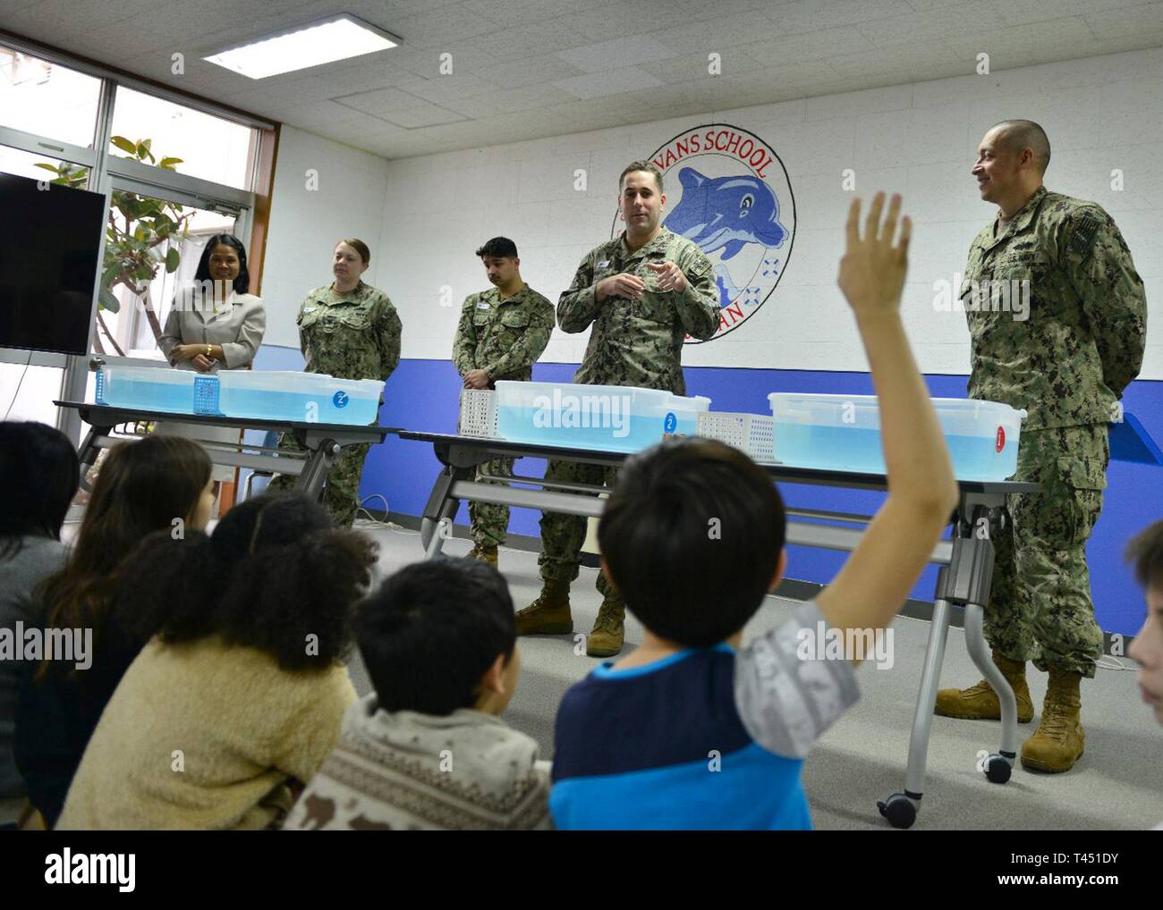 Japan (Feb. 26, 2019) Lt. John Pinachio, assigned to Naval Facilities Engineering Command Far East’s public works department, explains the job of an engineer to students during a foil boat competition at The Sullivans Elementary School at Fleet Activities (FLEACT) Yokosuka, Feb. 26, 2019.  The foil boat competition is an event during National Engineers Week emphasizing the importance of learning math, science and technical skills. FLEACT Yokosuka provides, maintains, and operates base facilities and services in support of the U.S. 7th Fleet's forward-deployed naval forces, 71 tenant commands,  Stock Photo