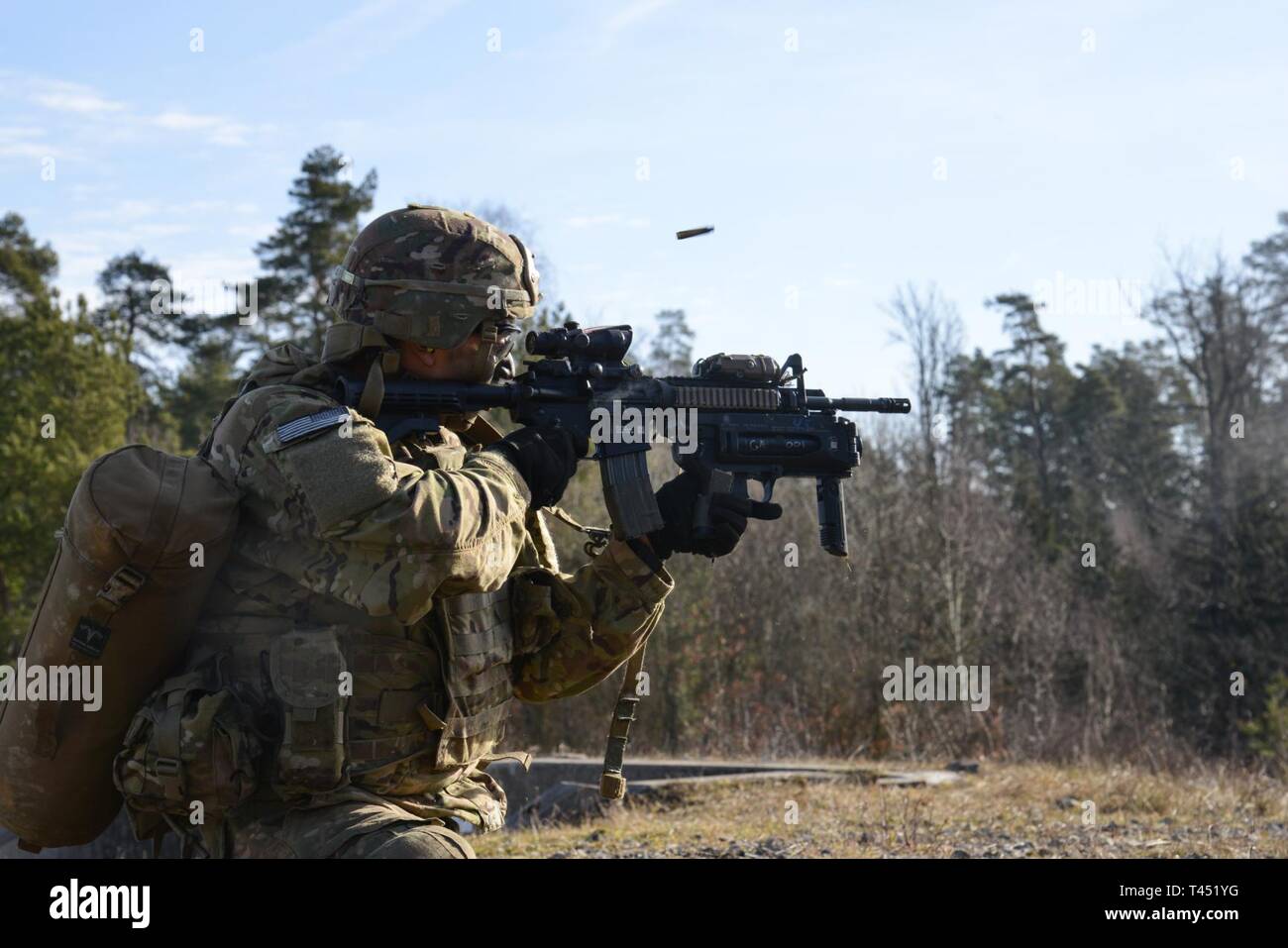 A U.S. paratrooper scans for targets behind a Barrett .50-caliber sniper  rifle while on a