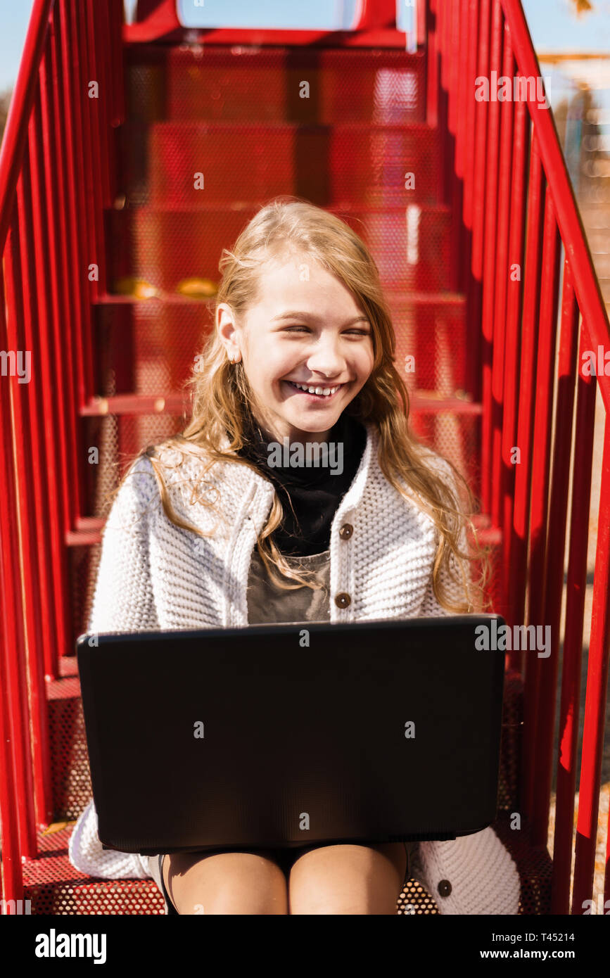 happy student smiles. young girl laughs. teenager sitting on the red ...