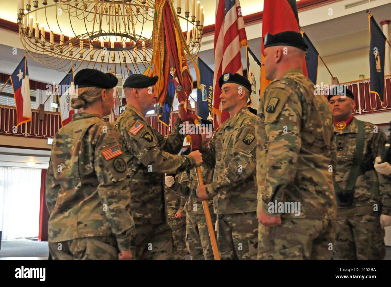 Lt. Col. Brandon H. Ungetheim, 39th Transportation Battalion (Movement Control), 16th Sustainment Brigade, incoming battalion commander (left), passes the unit colors to Command Sgt. Maj. Michael D. Russell, senior enlisted advisor, 39th Trans. Bn., during a Change of Command ceremony at the Armstrong Club, Kaiserslautern, Germany, Feb. 26, 2019. During the ceremony, Lt. Col. William R. Kost, outgoing battalion commander, formally passed accountability, authority and command of the battalion to Ungetheim. Stock Photo