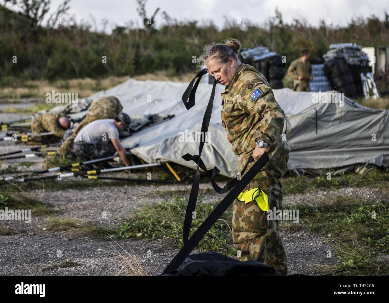 ARoyal Australian Air Force member prepares to build tents exercise during Cope North 19 in Tinian, U.S. Commonwealth of the Northern Marianas Islands Feb 26, 2019.  Cope North is an annual multilateral U.S. Pacific Air Forces-sponsored field training exercise focused on combat air forces large-force employment and mobility air forces humanitarian assistance and disaster relief training to enhance interoperability among U.S., Australian and Japanese forces. Stock Photo