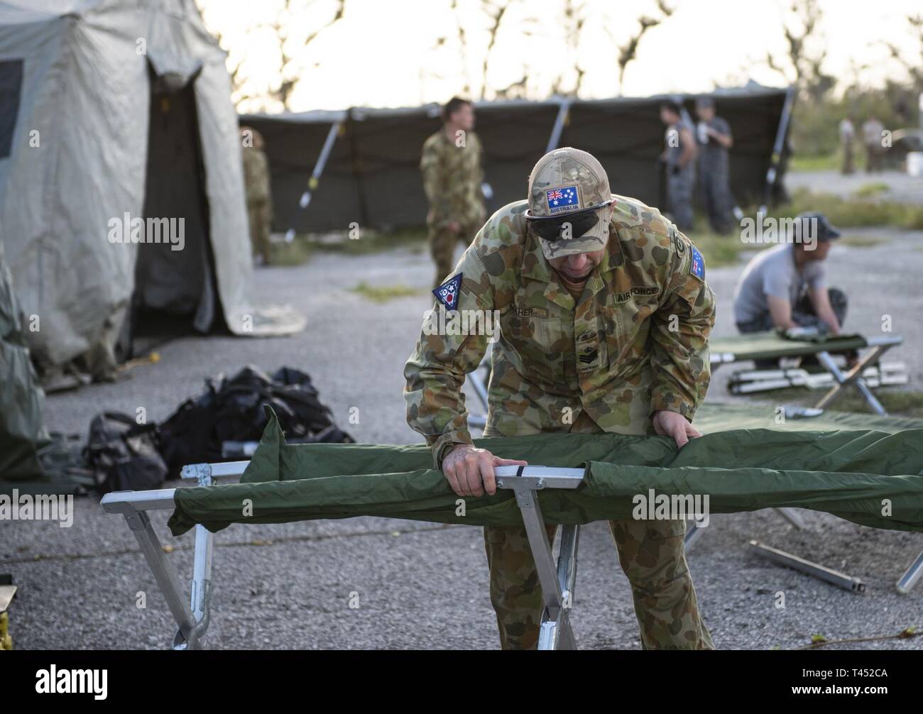A Royal Australian Air Force member builds cot during exercise Cope North 19 in Tinian, U.S. Commonwealth of the Northern Marianas Islands Feb 26, 2019. Cope North is an annual multilateral U.S. Pacific Air Forces-sponsored field training exercise focused on combat air forces large-force employment and mobility air forces humanitarian assistance and disaster relief training to enhance interoperability among U.S., Australian and Japanese forces. Stock Photo