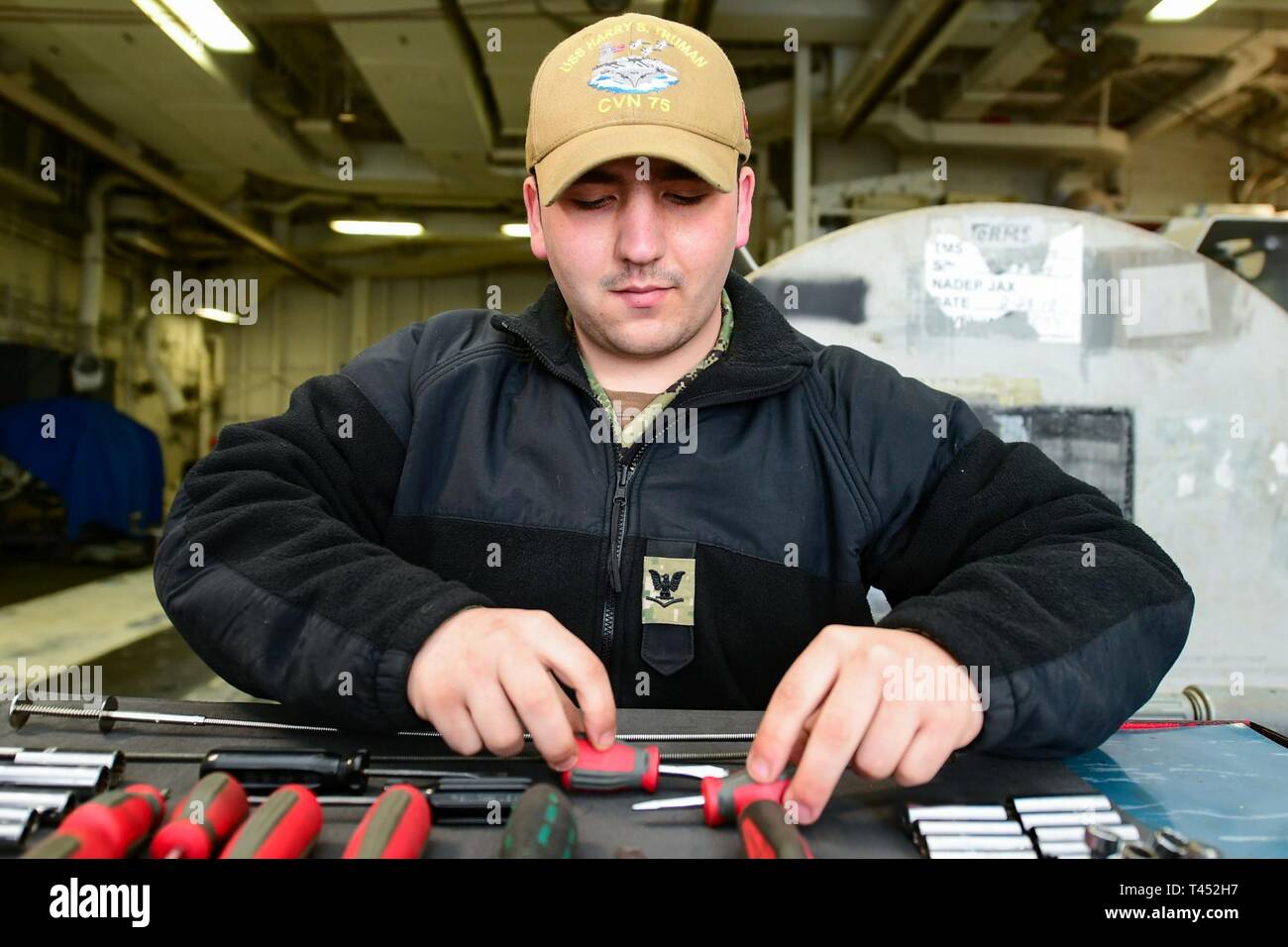 NORFOLK, Va. (Feb. 27, 2019) Aviation Machinist's Mate 3rd Class Ace Caldwell organizes tools prior to maintenance in the jet shop aboard the Nimitz-class aircraft carrier USS Harry S. Truman (CVN 75). Harry S. Truman is currently moored at Naval Station Norfolk conducting targeted maintenance and training, and remains operationally ready. Stock Photo