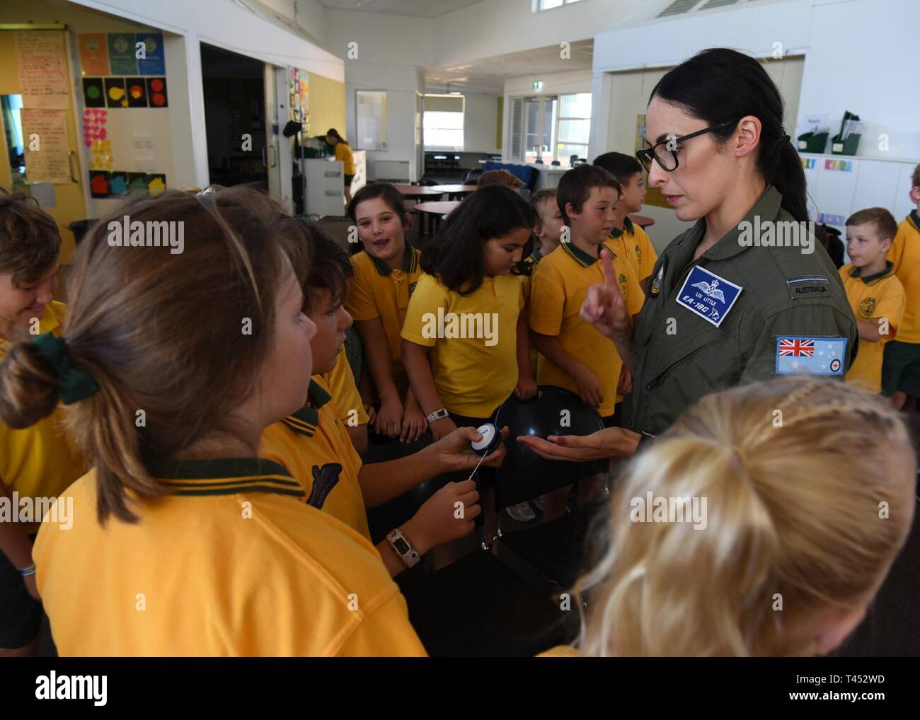 Royal Australian Air Force Flying Officer Olivia Little, electronic warfare officer with the No. 6 Squadron, Amberly, Queensland, Australia, hands out souvenirs to Lara Primary School students at Geelong, Victoria, Australia, Feb. 26, 2019. During the visit, Little talked to students about why she joined the Air Force and her job duties. Stock Photo
