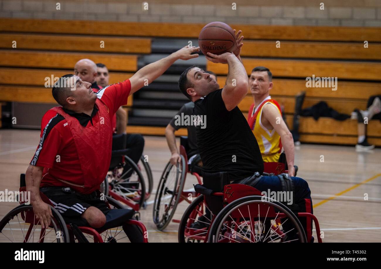 A Georgian athlete attempts a shot during a wheelchair basketball practice at  the 2019 Marine Corps Trials at Marine Corps Base Camp Pendleton, California, Feb. 27. The Marine Corps Trials promotes rehabilitation through adaptive sports participation and serves as the primary venue to select Marine Corps participants for the DoD Warrior Games. (Official U.S. Marine Corps Stock Photo