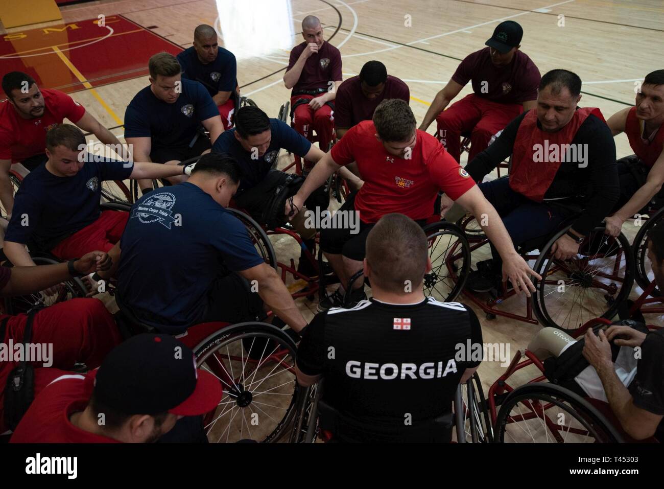 Coach Joey Gugliotta breaks down the participants after a wheelchair basketball practice during the 2019 Marine Corps Trials  at Marine Corps Base Camp Pendleton, California, Feb. 27. The Marine Corps Trials promotes rehabilitation through adaptive sports participation and serves as the primary venue to select Marine Corps participants for the DoD Warrior Games. (Official U.S. Marine Corps Stock Photo