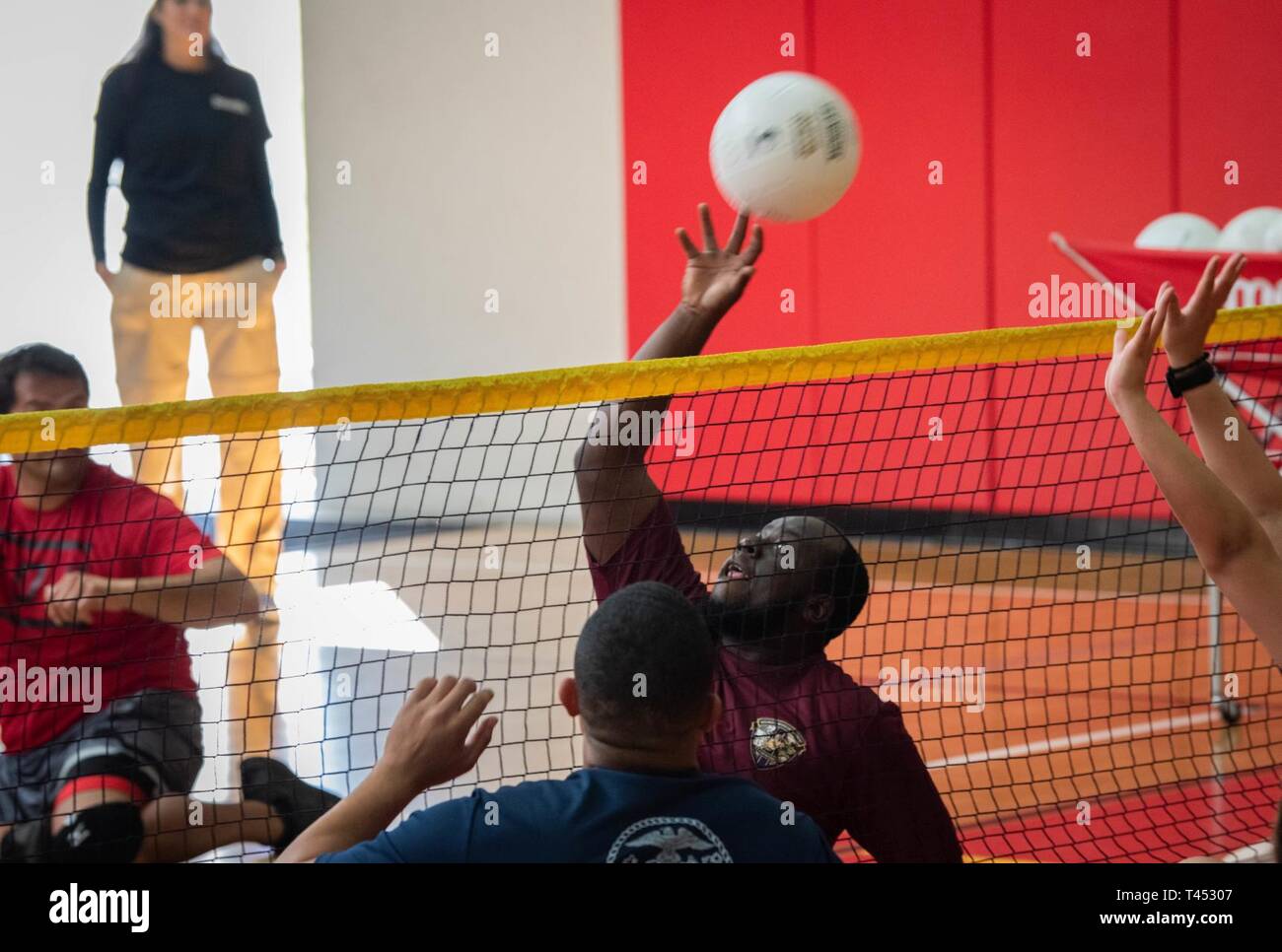 U.S. Marine Corps Lance Cpl. Joseph Meutz hits the ball at a sitting volleyball practice during the 2019 Marine Corps Trials at Marine Corps Base Camp Pendleton, California, Feb. 27. The Marine Corps Trials promotes rehabilitation through adaptive sports participation and serves as the primary venue to select Marine Corps participants for the DoD Warrior Games. (Official U.S. Marine Corps Stock Photo