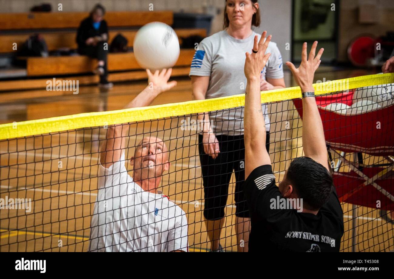 Dutch athlete Chief Warrant Officer 4 Dirk Vonk hits the ball at a sitting volleyball practice during the 2019 Marine Corps Trials at Marine Corps Base Camp Pendleton, California, Feb. 27. The Marine Corps Trials promotes rehabilitation through adaptive sports participation and serves as the primary venue to select Marine Corps participants for the DoD Warrior Games. (Official U.S. Marine Corps Stock Photo